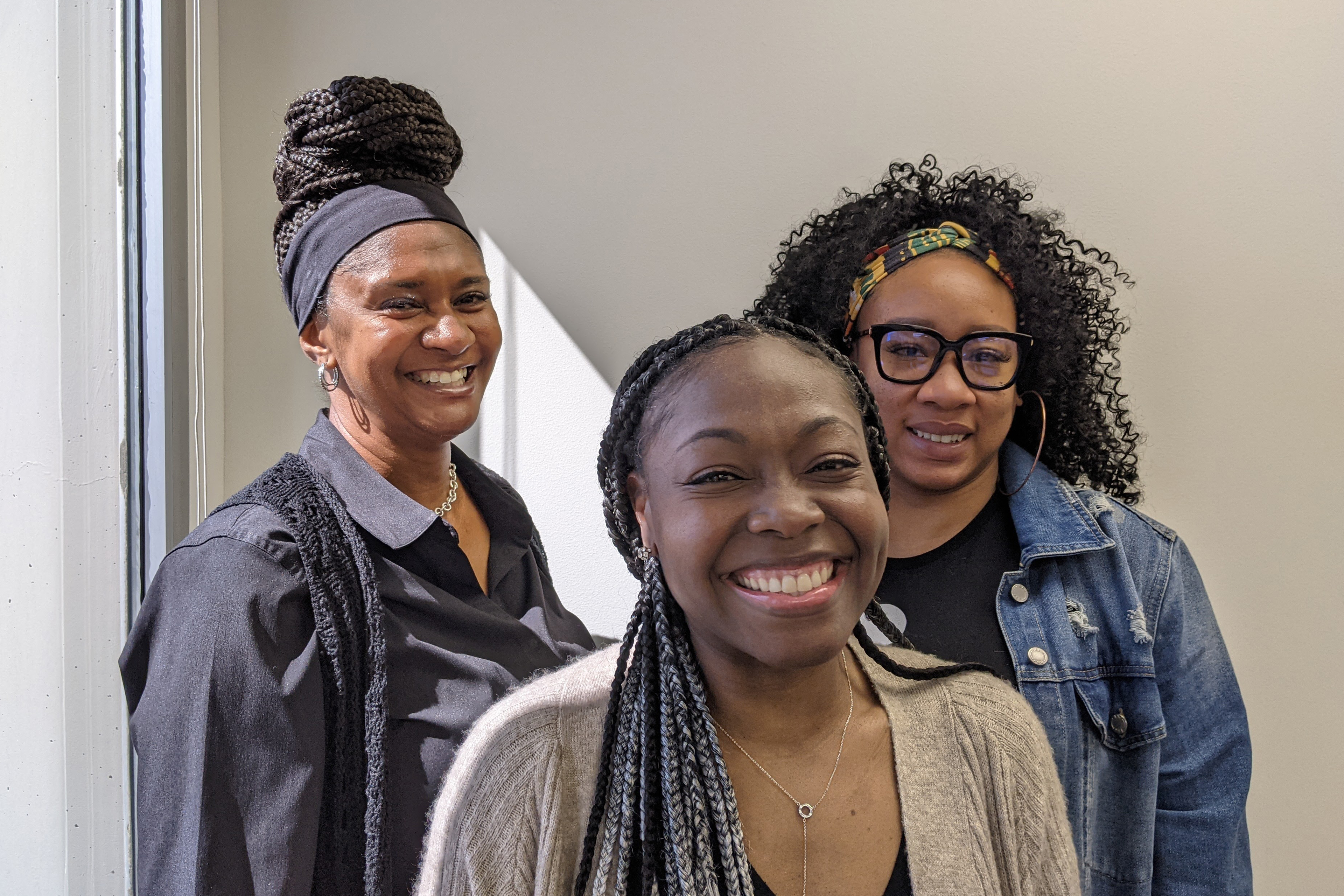 Shawn Taylor, Joy Senyah and Alliss Hardy of Families Forward Resource Center are seen posing for a picture, smiling.