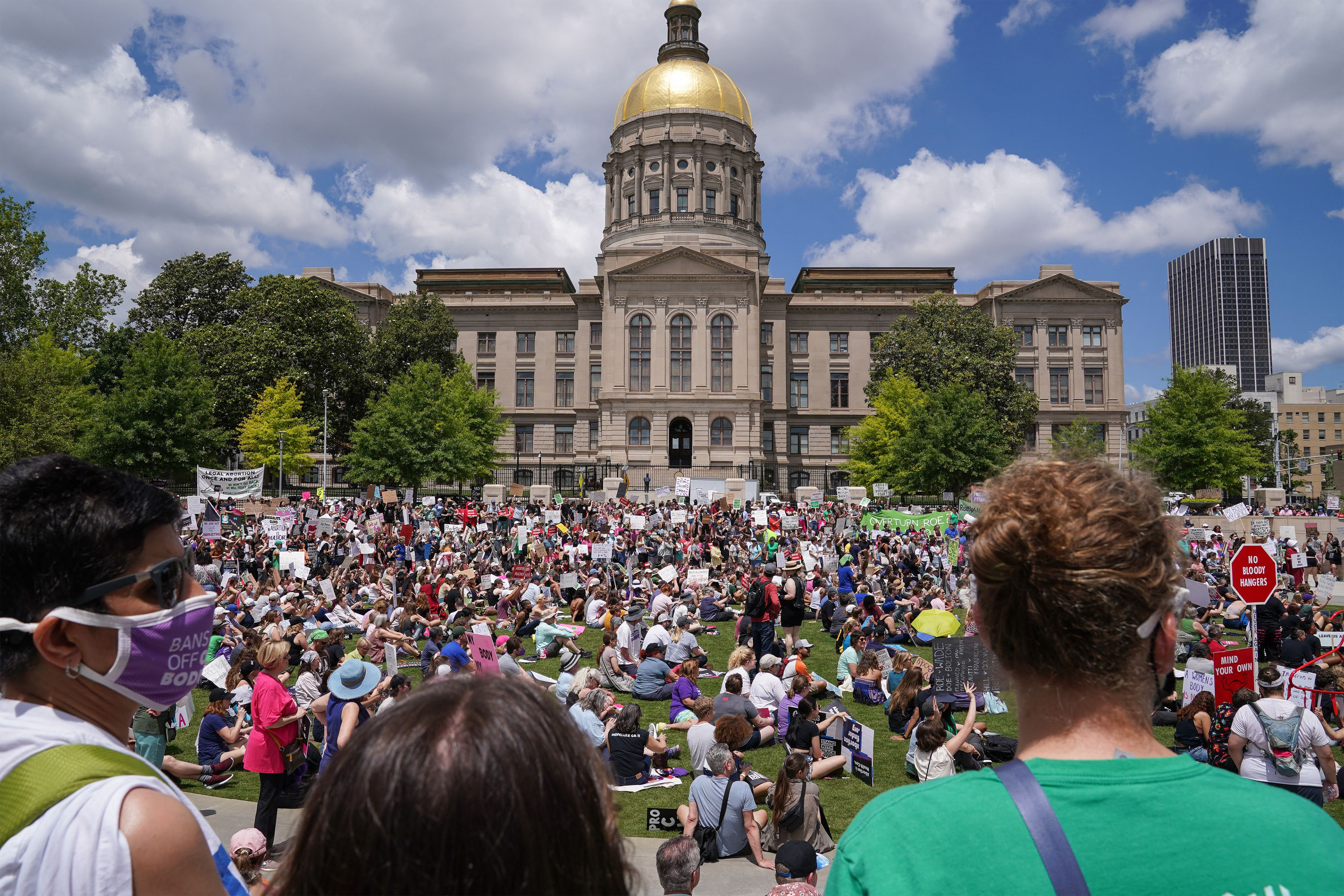A photo shows a crowd of pro-abortion activists holding signs and banners outside the Georgia Capitol.