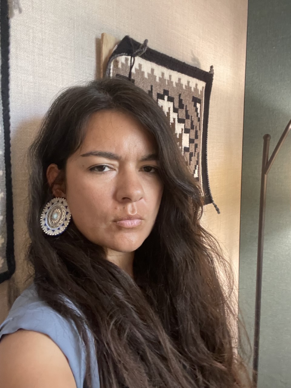 Lauren van Schilfgaarde poses for a selfie in front of a wall.