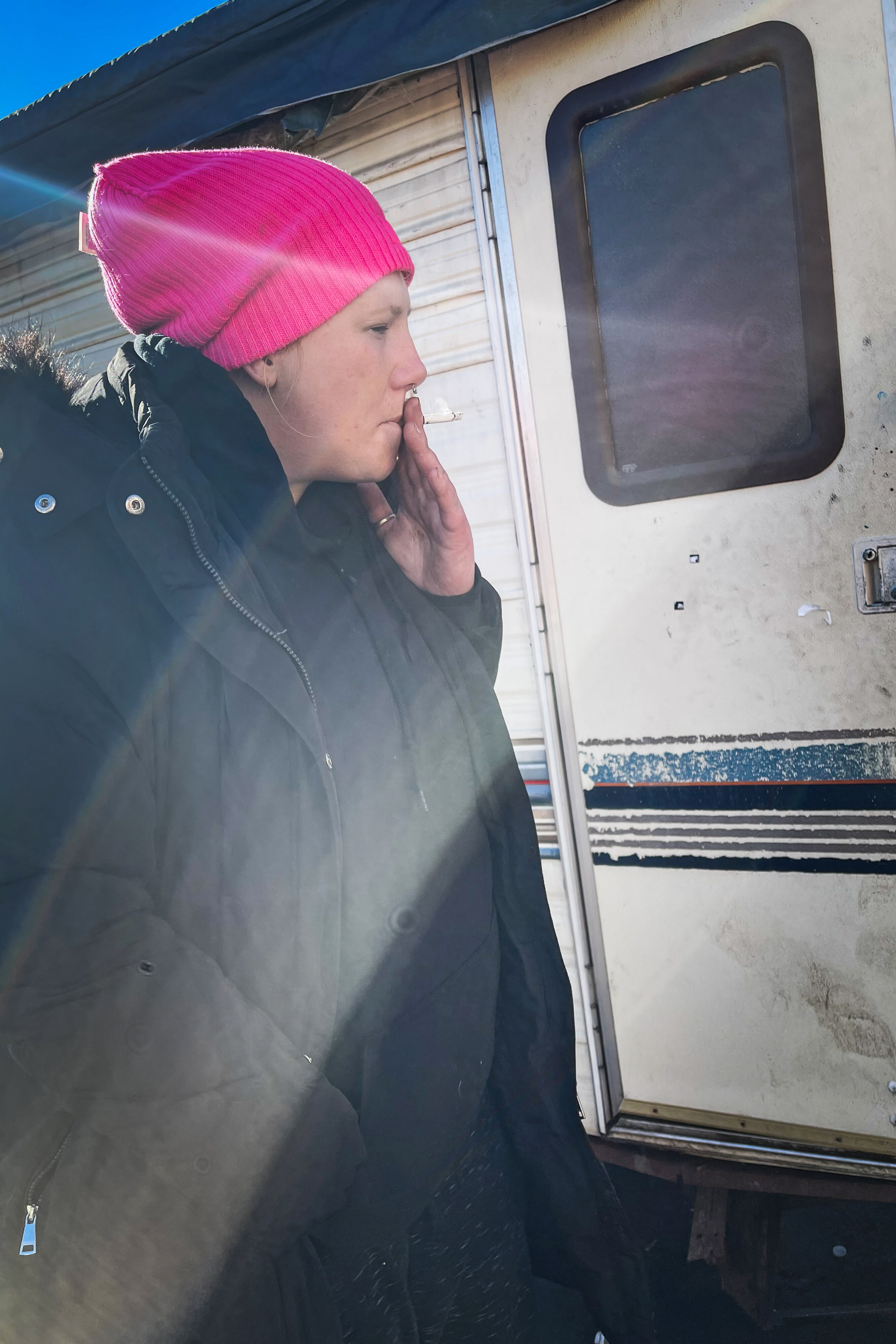 A photo shows Sarah Bennett from the side. She is smoking a cigarette.