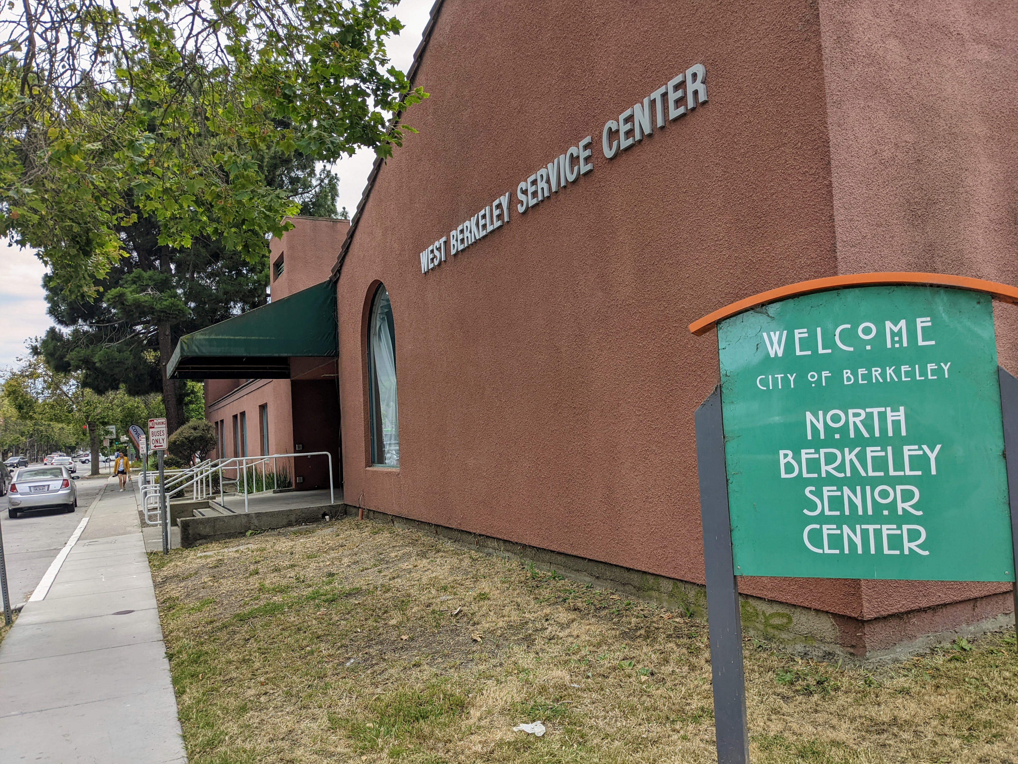 A photo shows the exterior of West Berkeley OptumServe. A sign out front reads, "North Berkeley Senior Center."