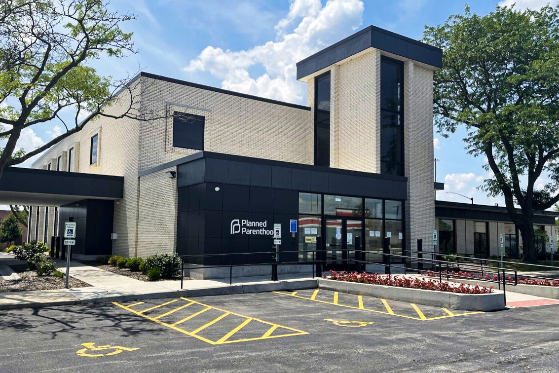 A photo shows the exterior and parking lot of a Planned Parenthood clinic.