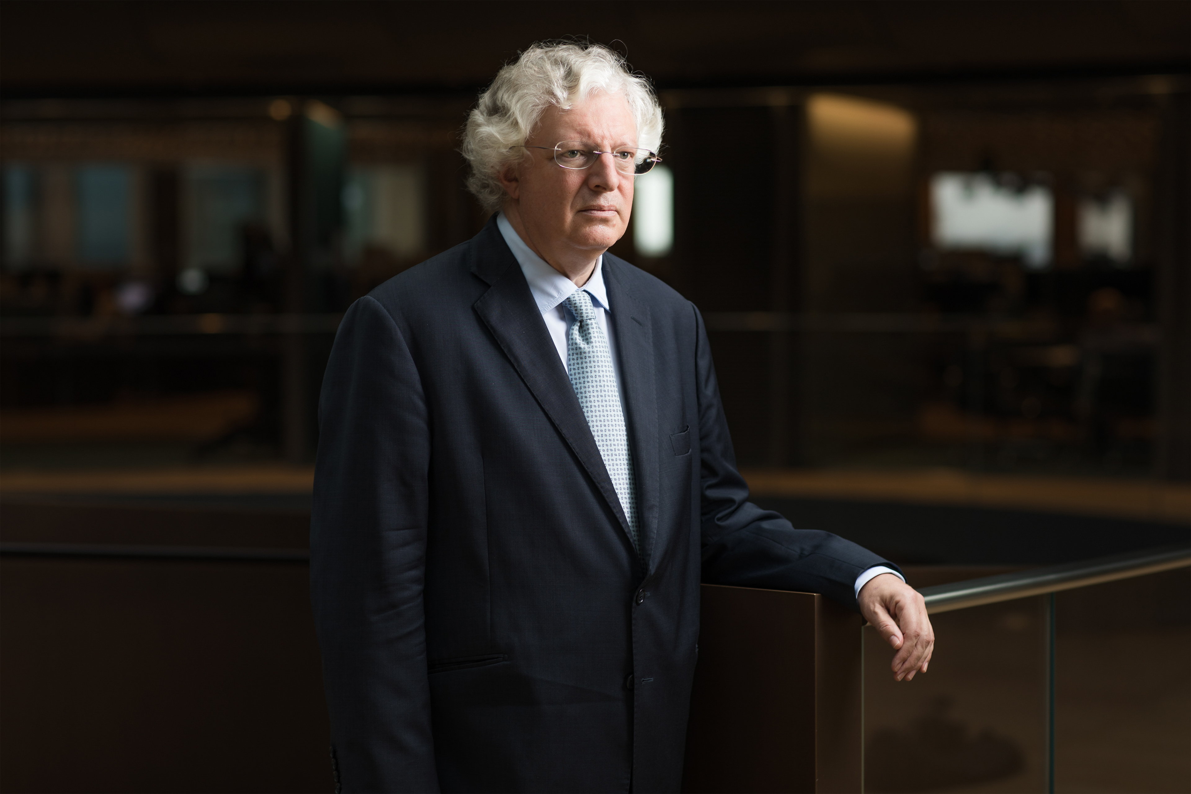 A photo shows Guy Hands posing for a portrait indoors.