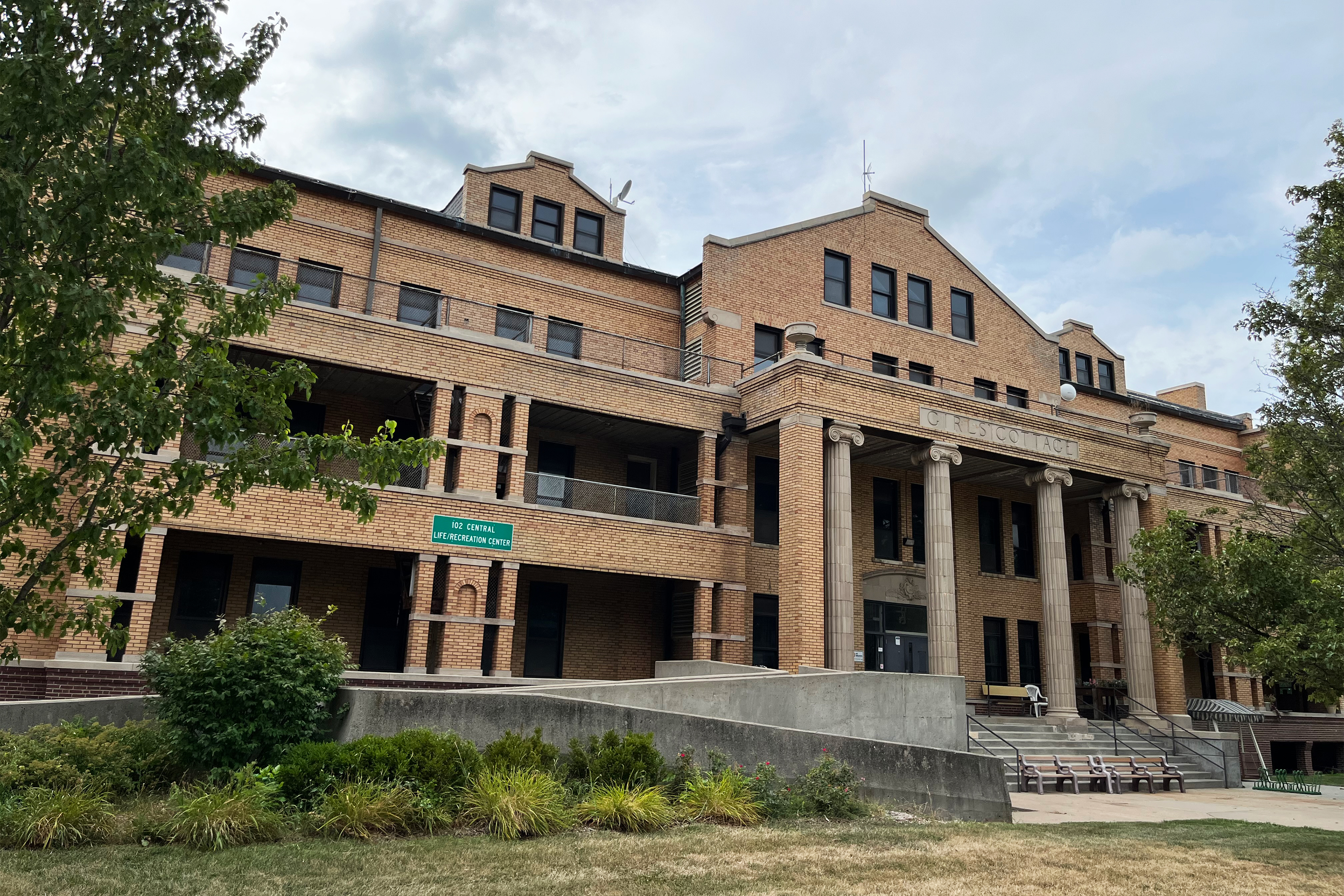 A photo shows one of Glenwood Resource Center's older buildings. It is a large brick building labelled, 