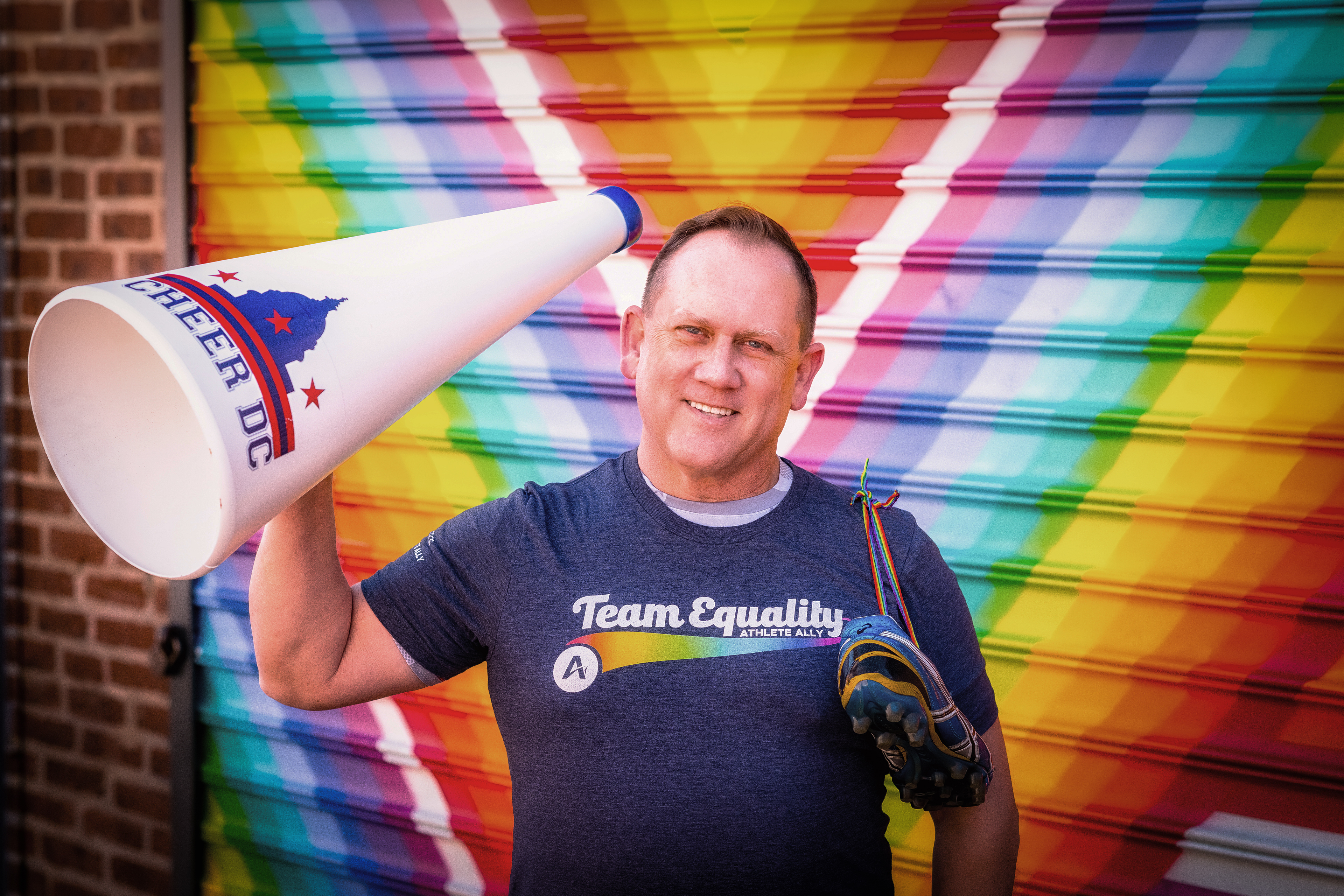A photo shows Robert York standing in front of a rainbow backdrop.