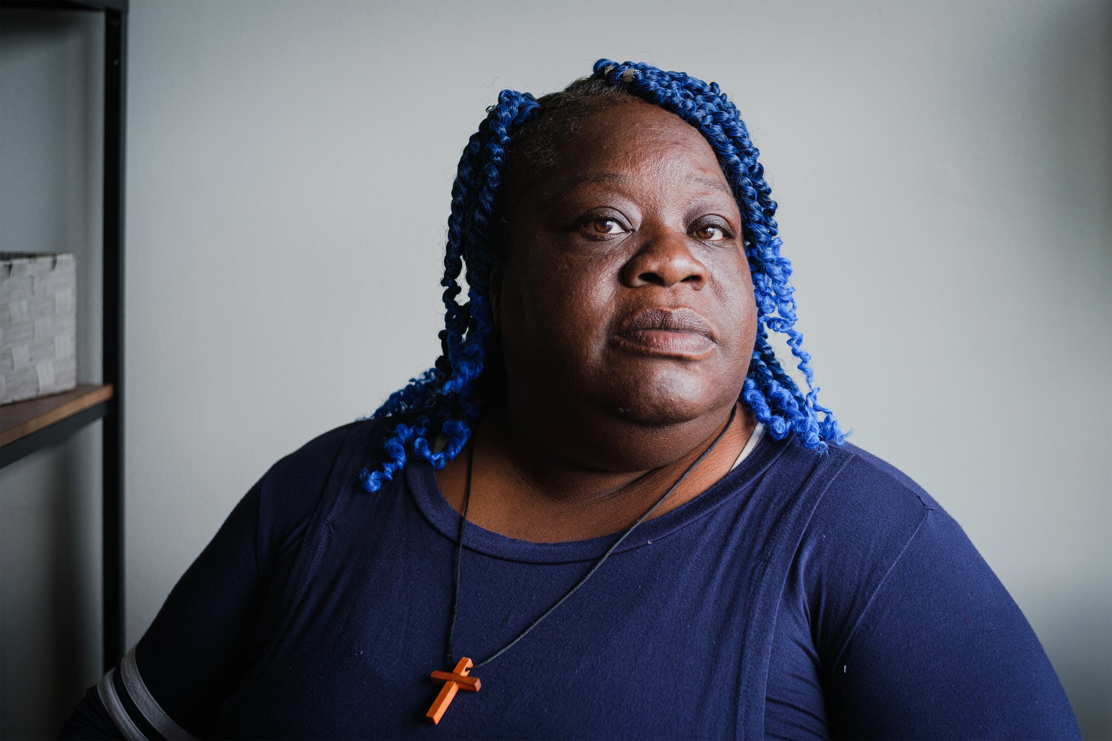 A photo shows Delisa Williams sitting beside a window. She is posing for a portrait and looking at the camera.