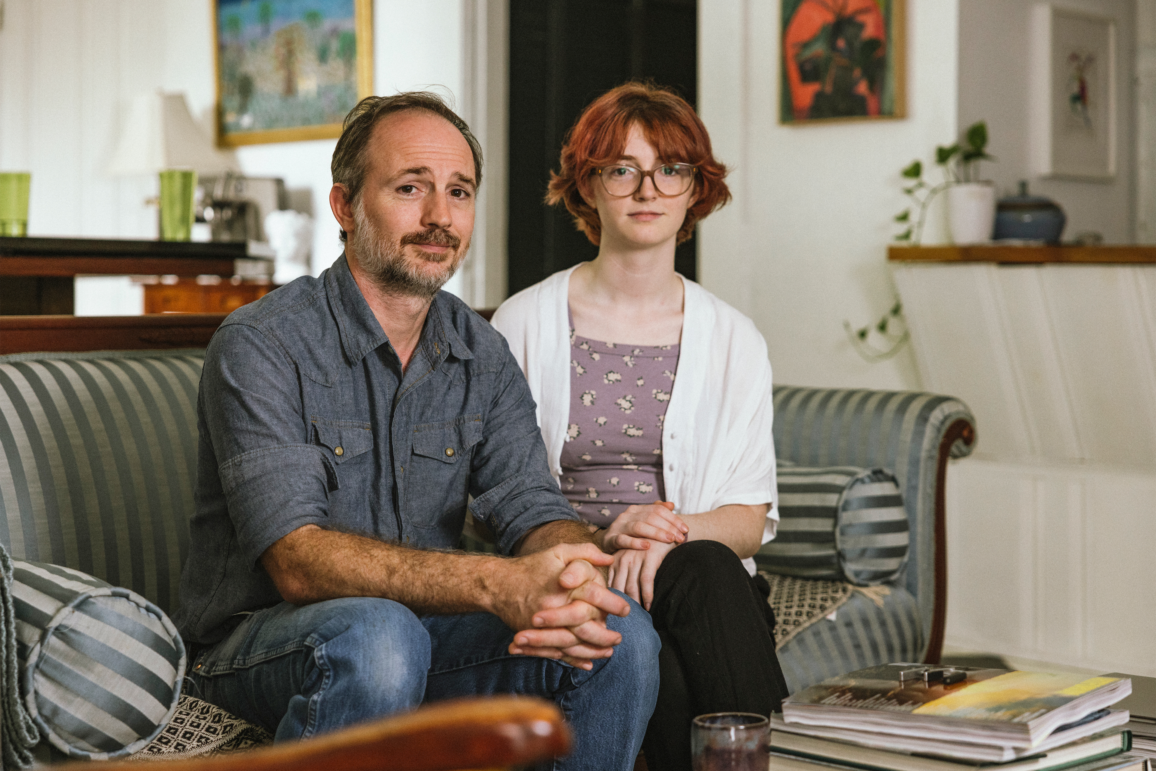 A photo shows Frankie and Russell Cook sitting on a sofa together, looking at the camera.