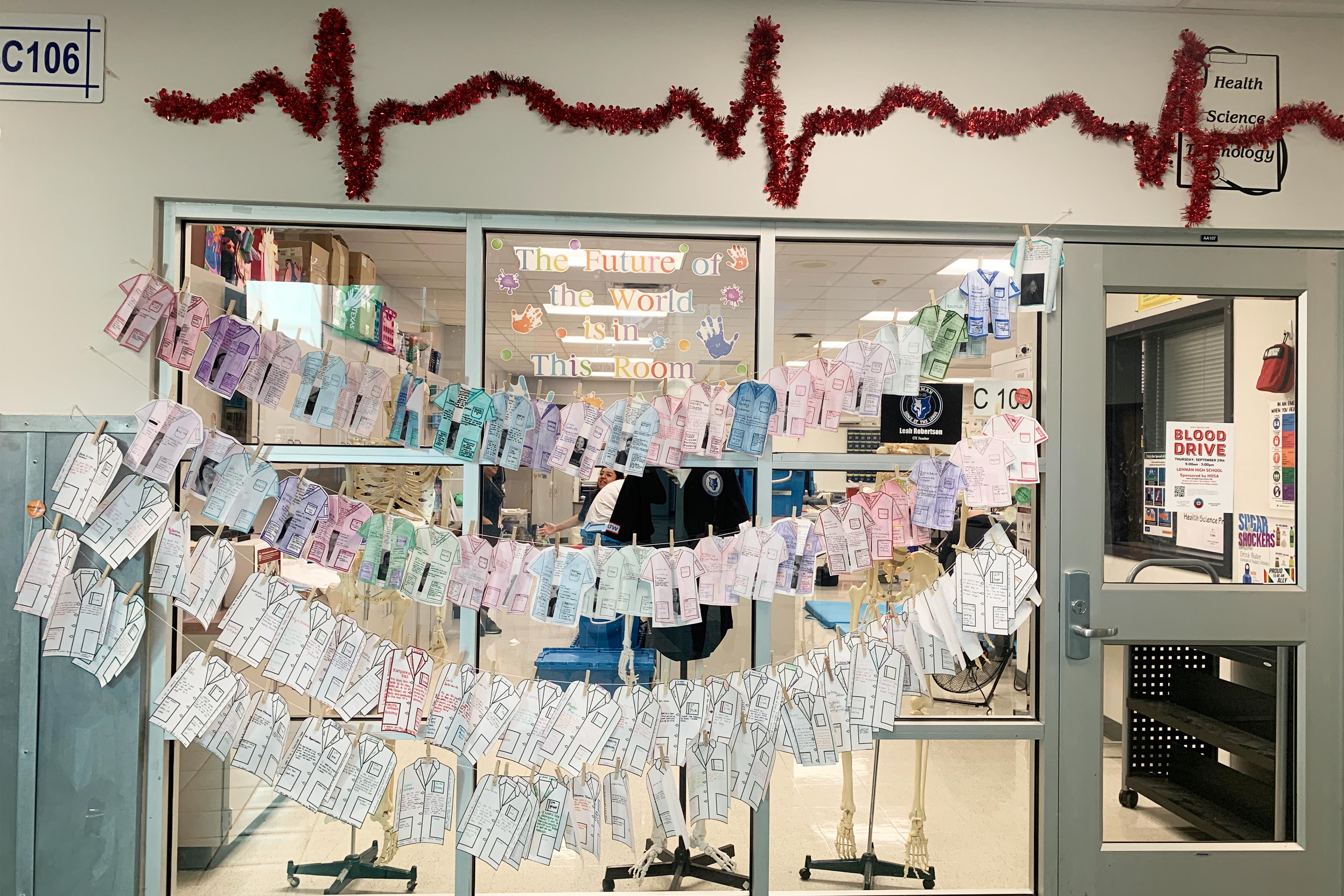 A photo shows rows of drawings of shirts strung over Lehman High's health care department.