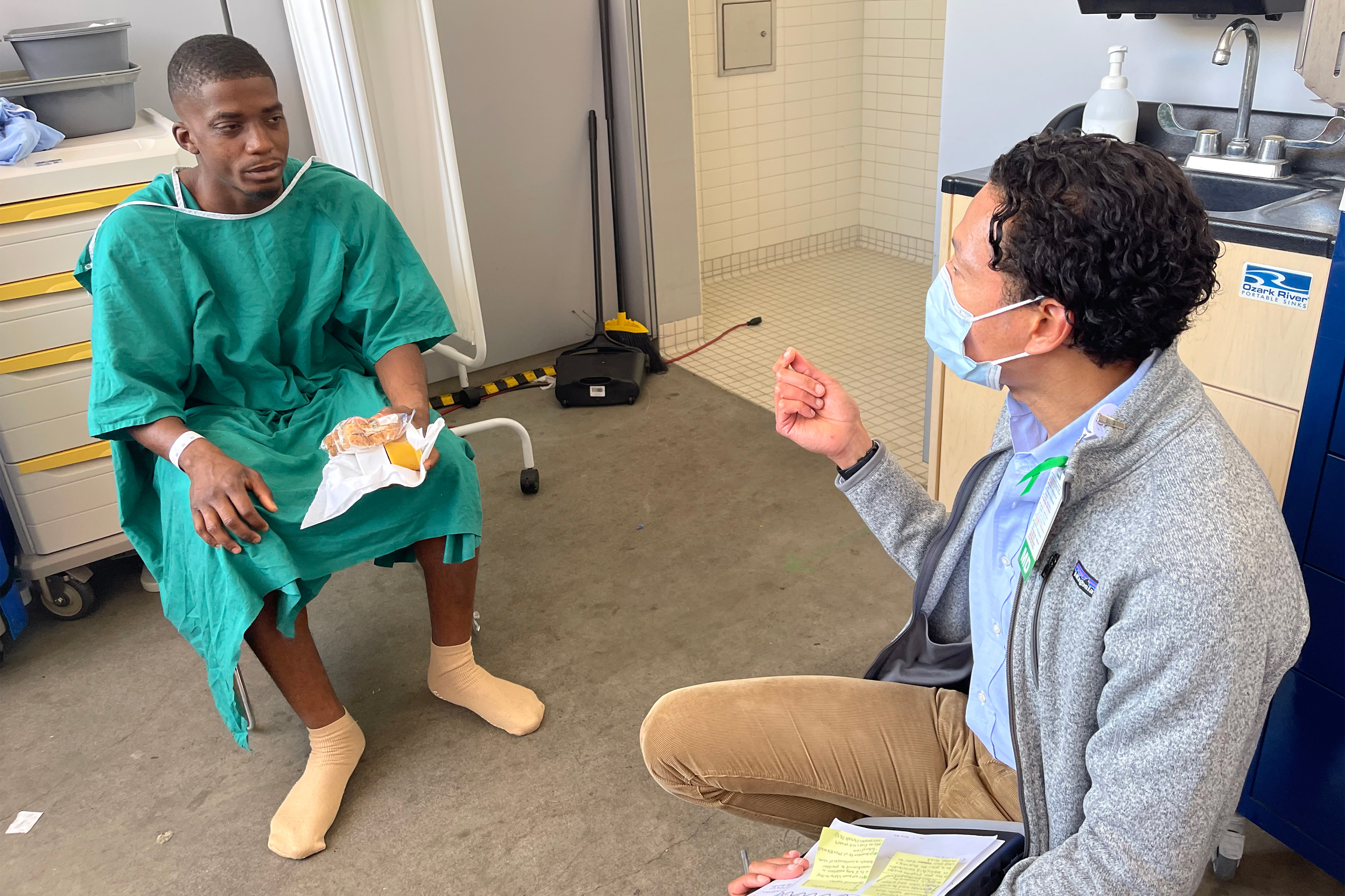 A photo shows Edward Green conversing with a doctor.