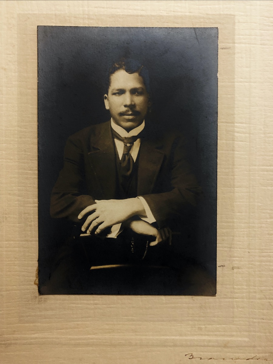 A black and white portrait from the early 20th century of a Black man in a suit.