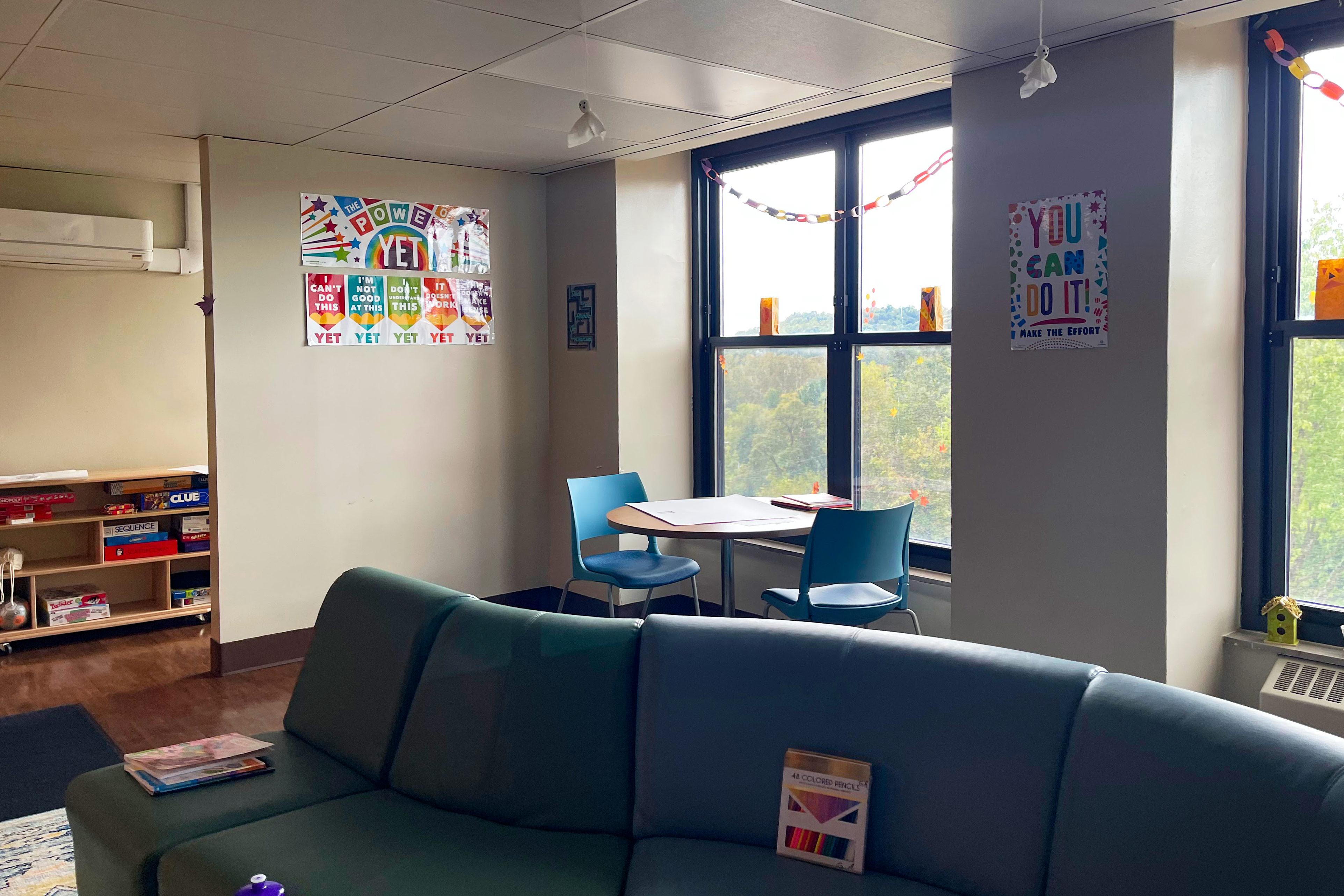 A photo shows the inside of the Mary Hill Youth and Family Center. Colorful signs on the walls read, "You can do it," and "the power of yet."
