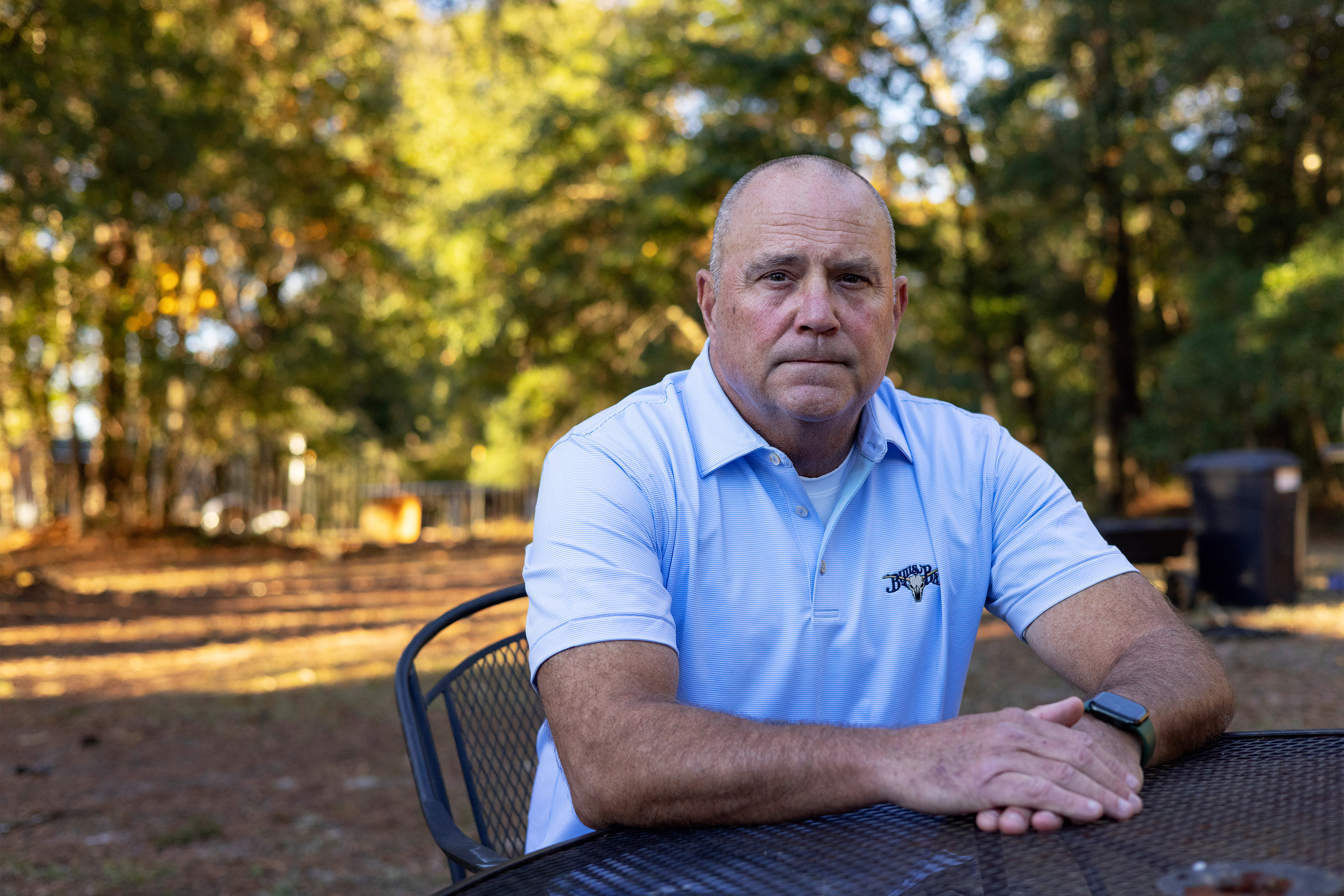 A photo shows John Lites sitting at a table outside.