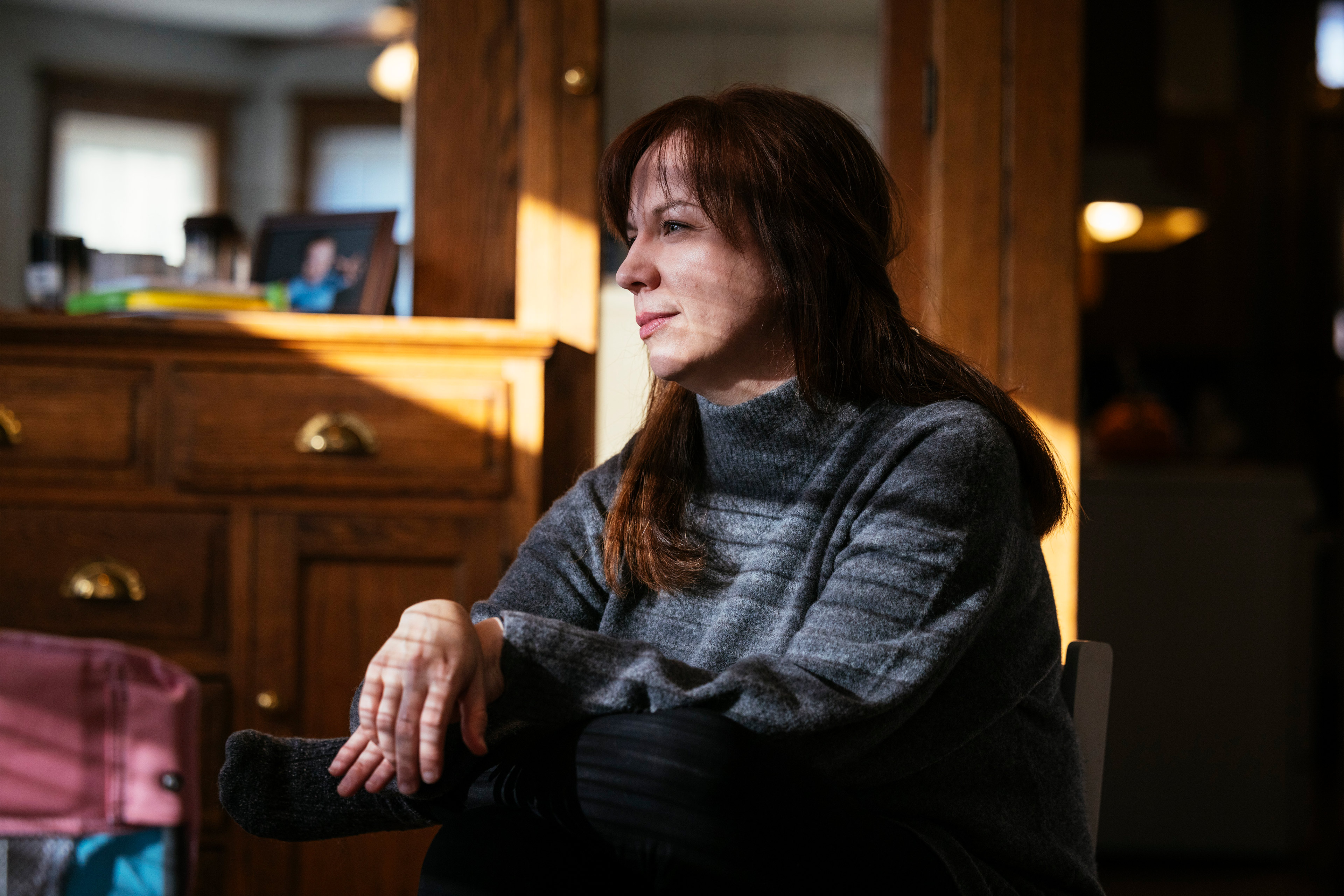 A photo shows Brenna Kearney posing for a portrait in her home.