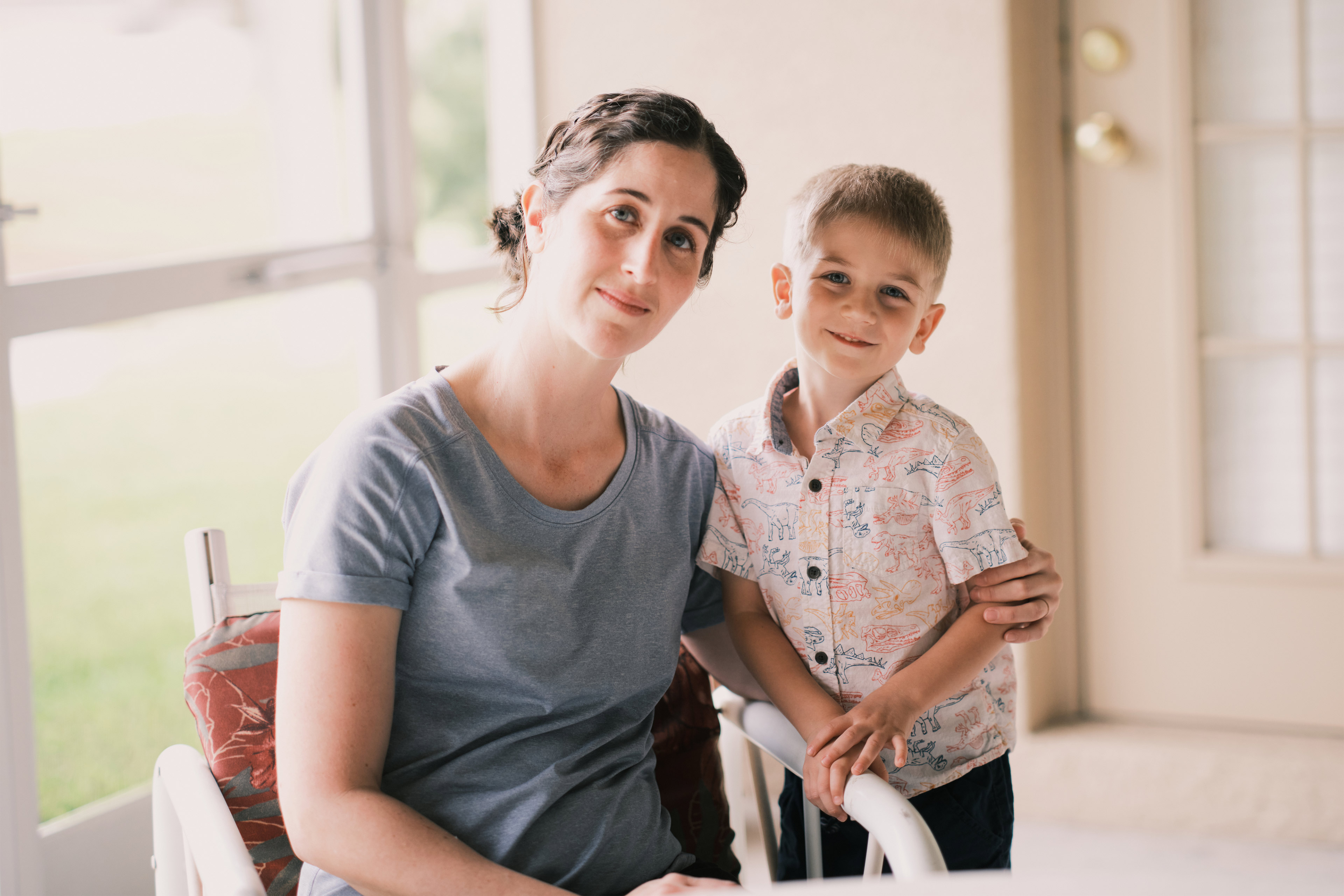 A photo of a mother and her son posing for a portrait together.