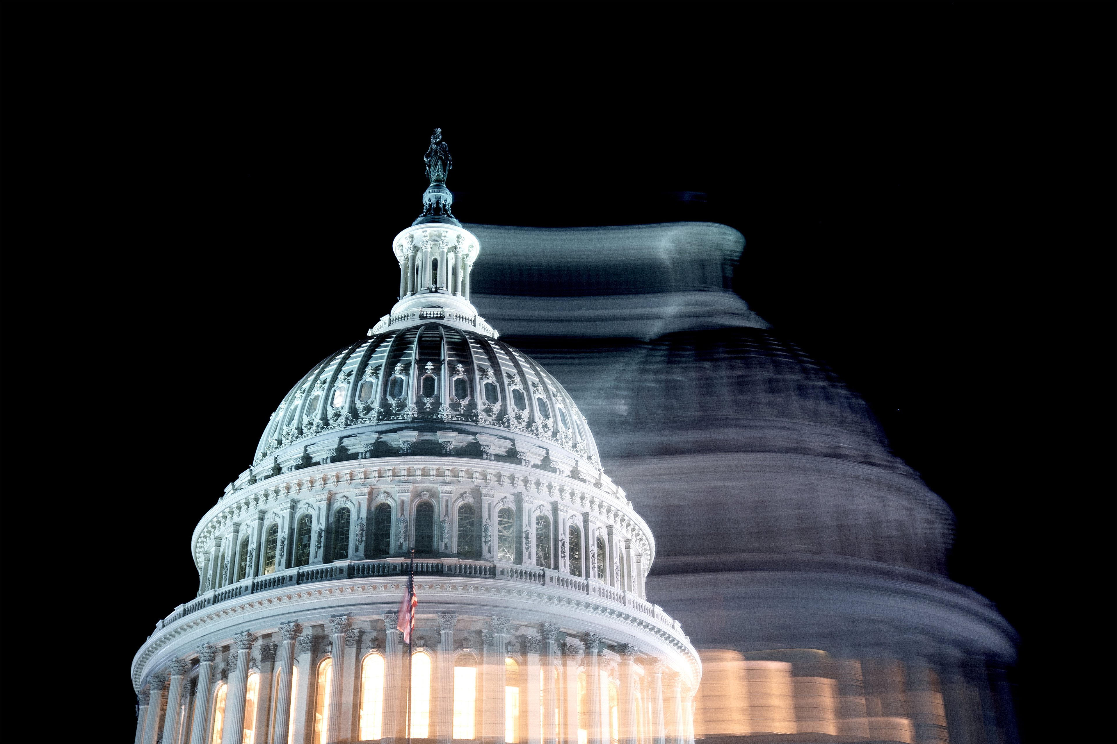 A photo of the U.S. Capitol building against a dark sky.