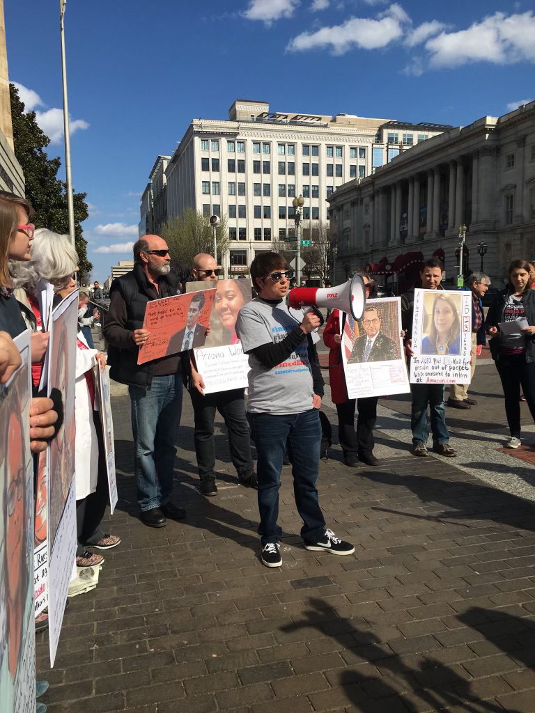 A photo shows a woman holding up a megaphone at a protest.