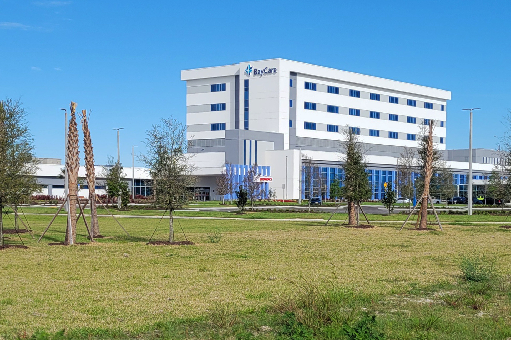 A photo of a hospital building with a sign that reads, "BayCare."