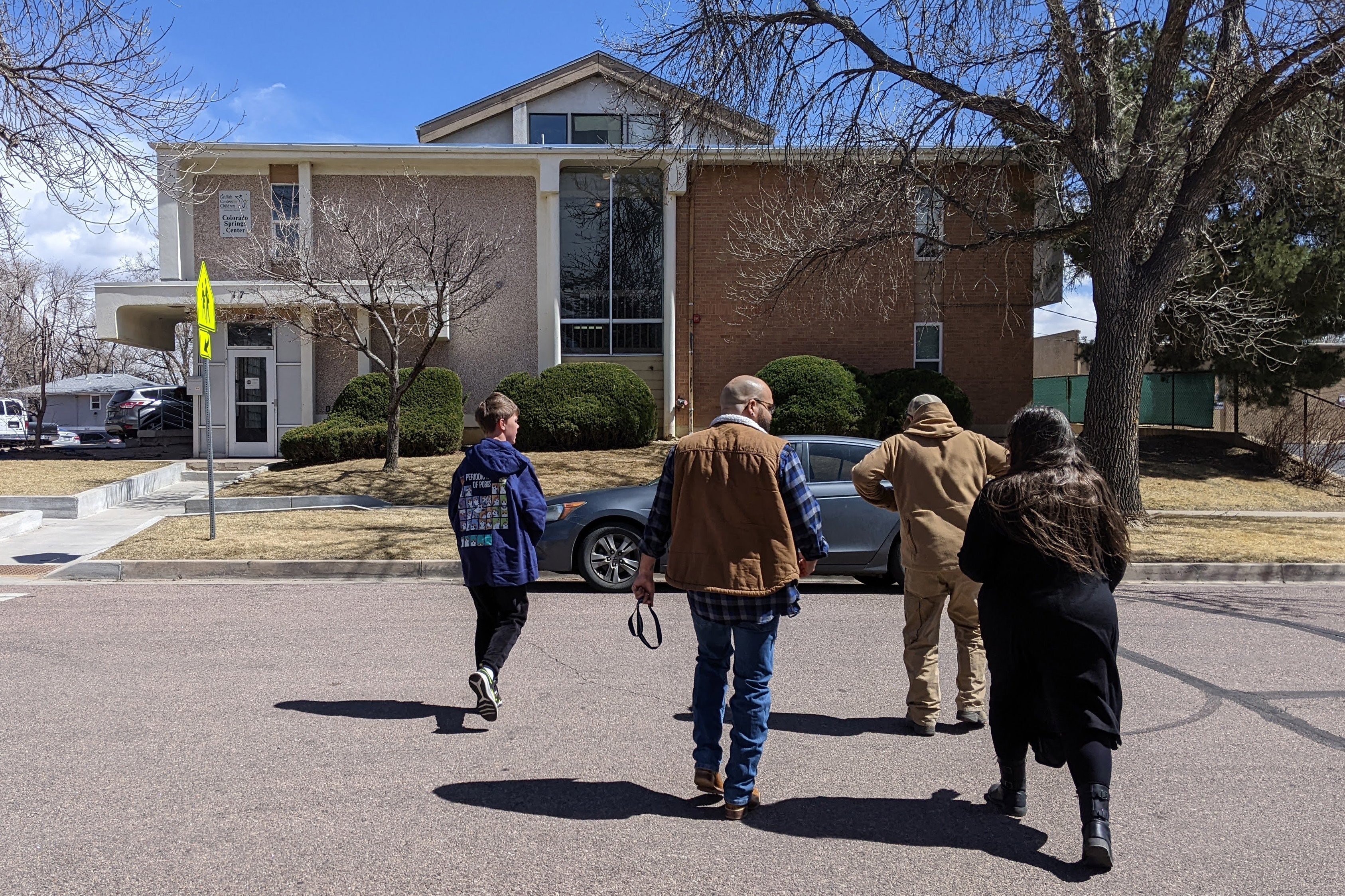 A photo of Riley George and his family getting a tour of the J. Wilkins Opportunity School.