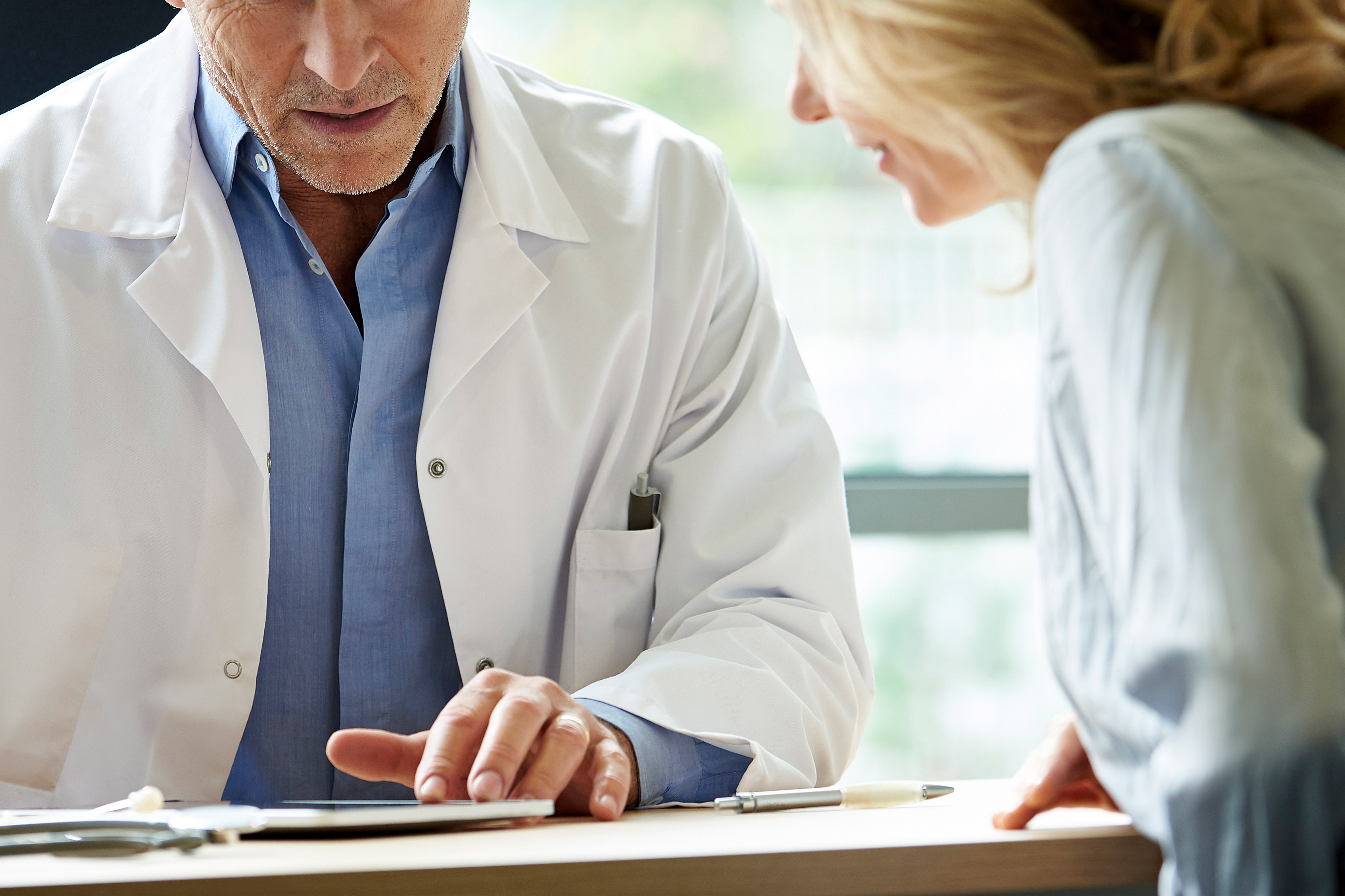 A photo of a male doctor counseling a female patient.