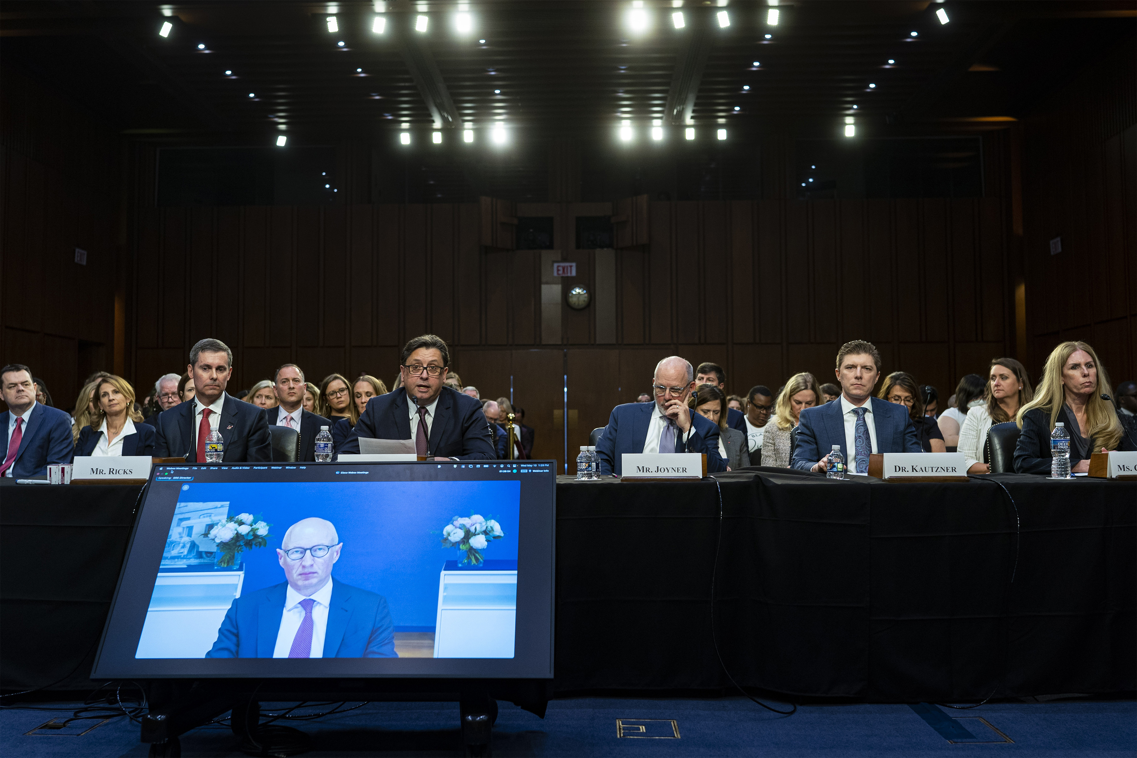 A photo of a line of health industry executives sitting next to each other during a Senate HELP Committee hearing.