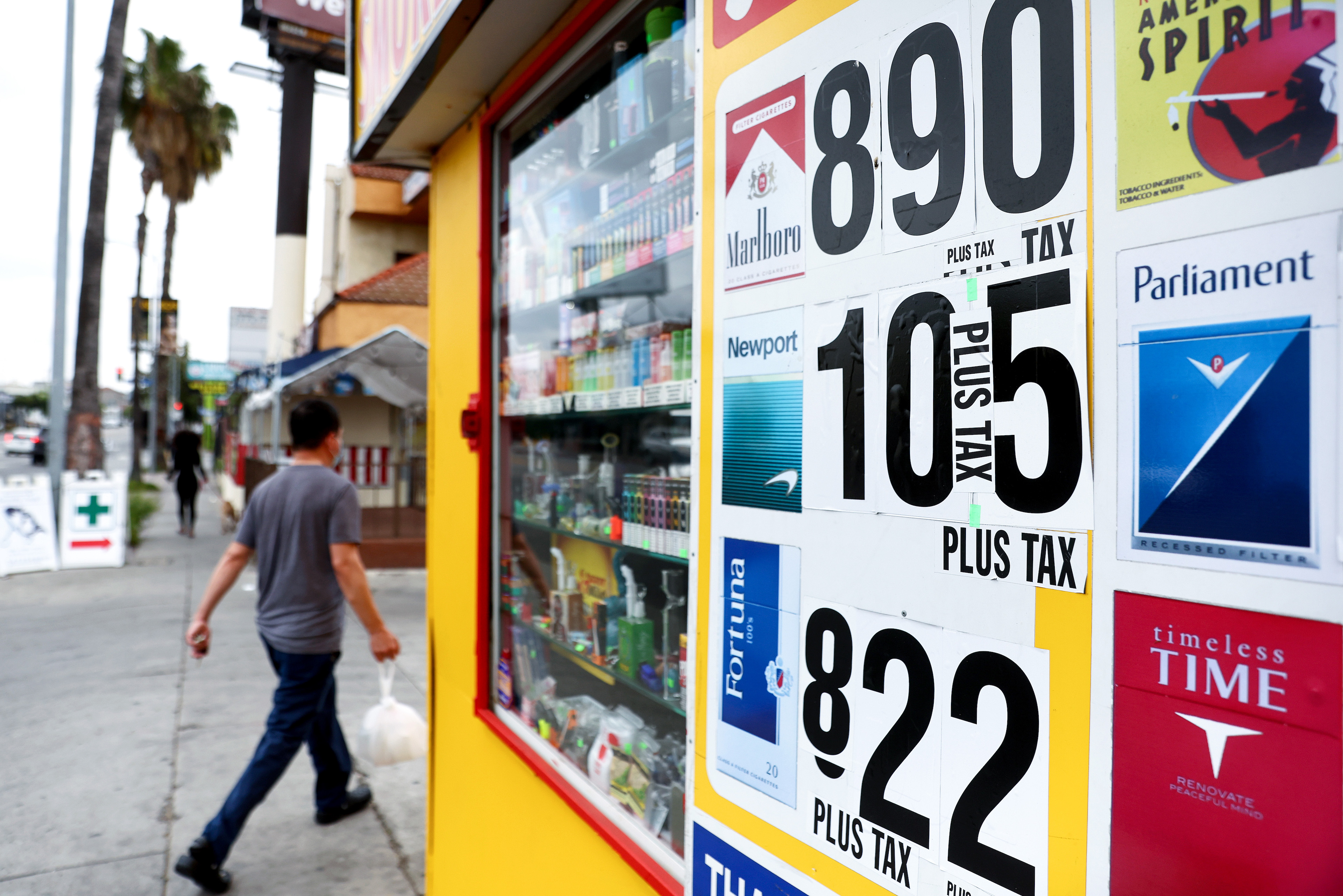 A photo of various cigarette brands being advertised outside of a store.