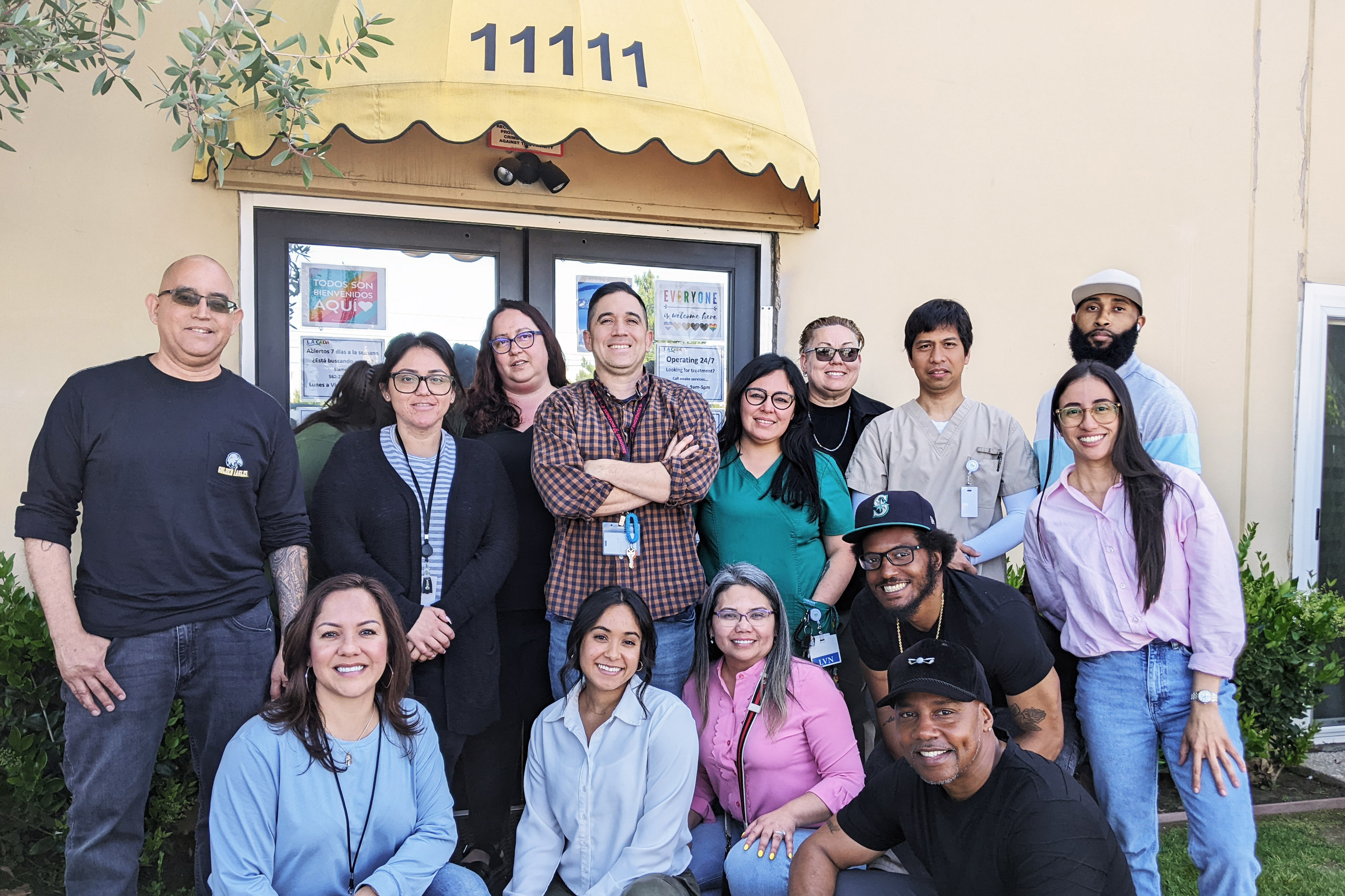 A photo of people posing for a photo outside of a residential treatment center.