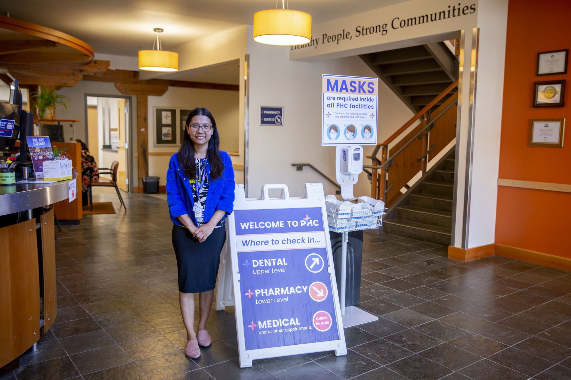 A photo of a woman posing inside of a dental clinic.