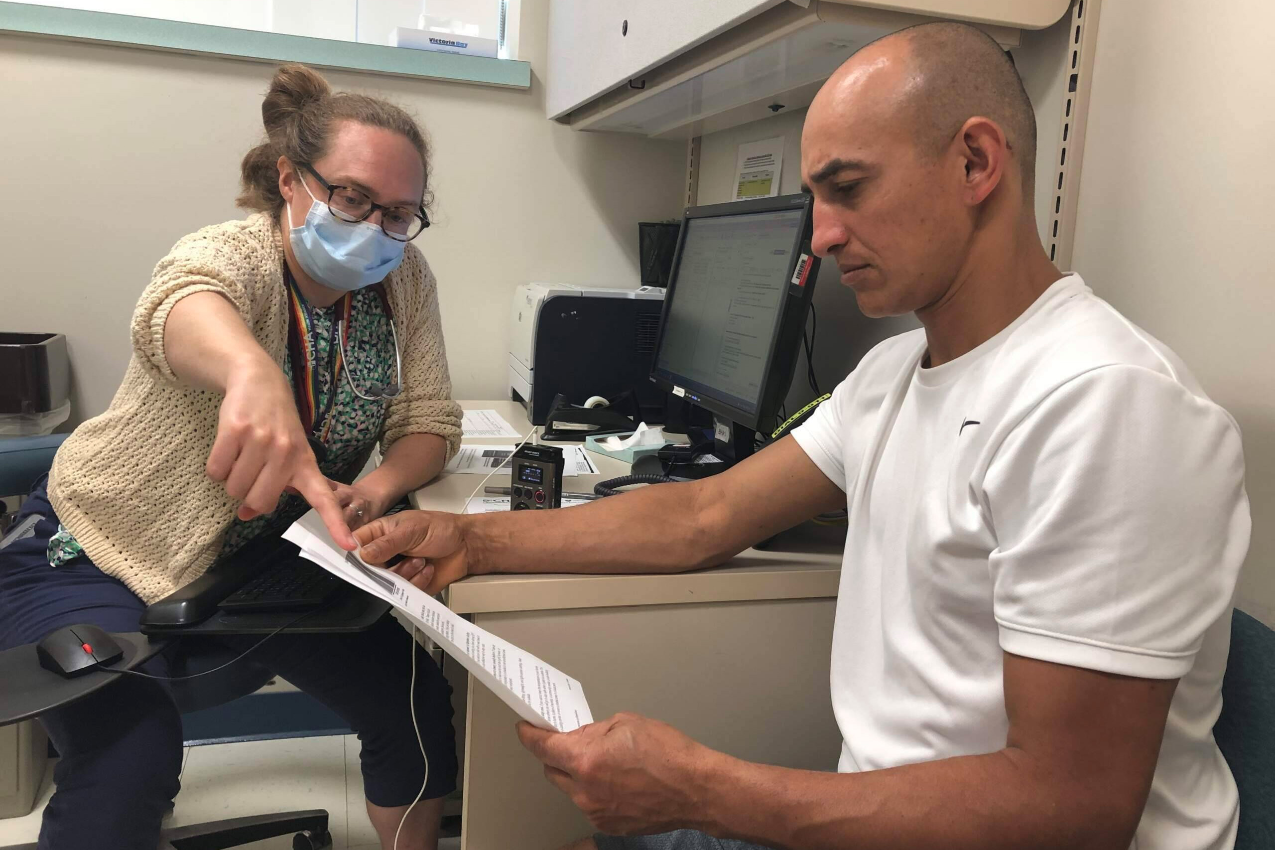 A photo of a doctor speaking to a patient.