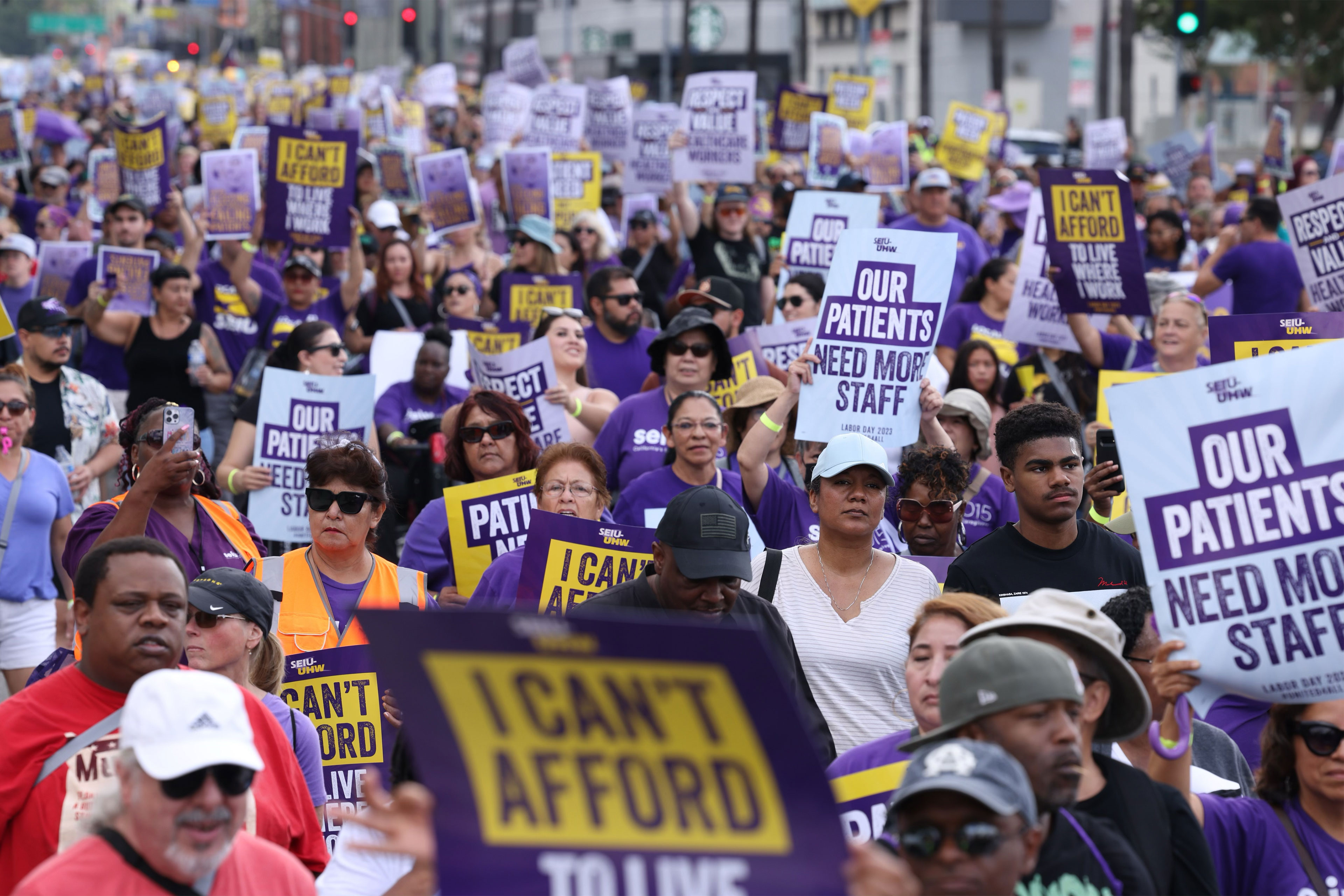 A photo of protesters holding signs in a crowd.