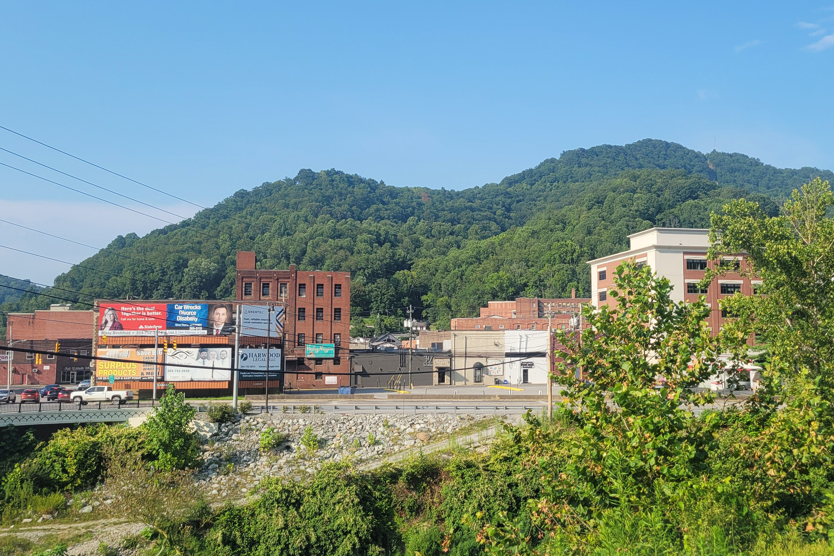 A photo of a downtown area with mountains seen in the background.