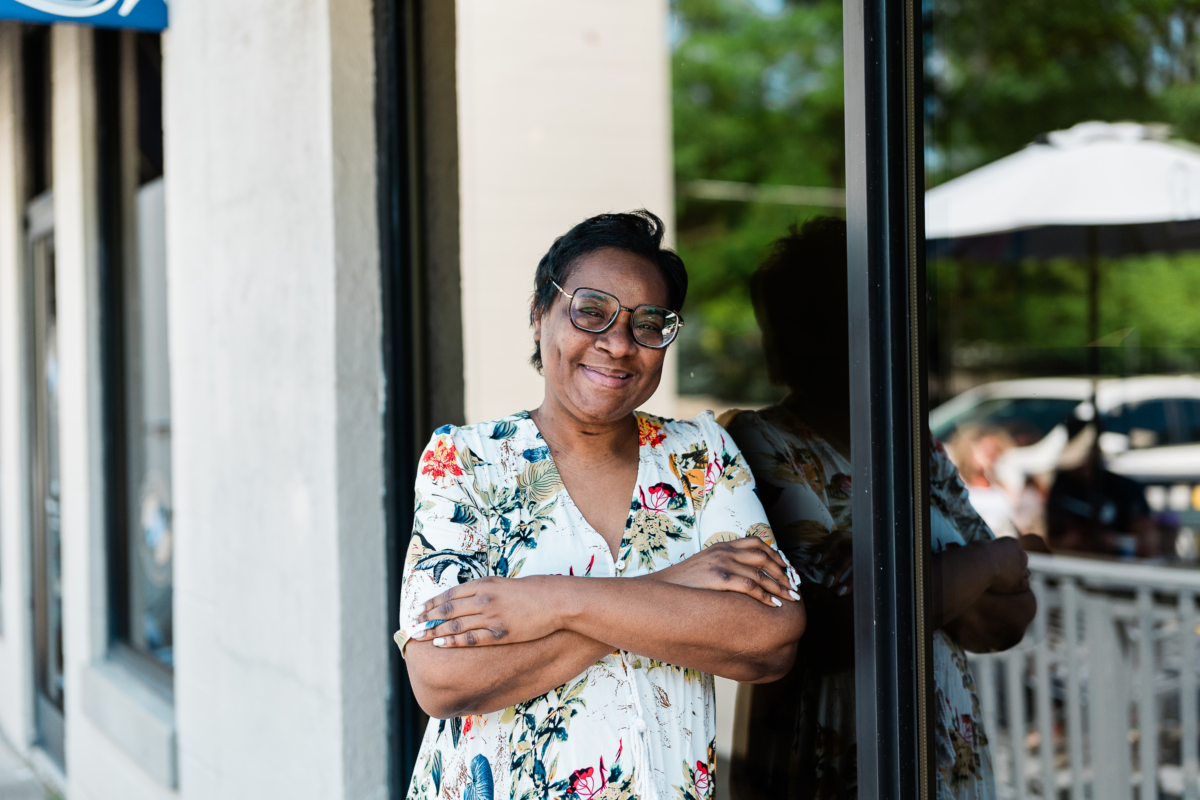 A photo of a woman standing outside for a portrait.
