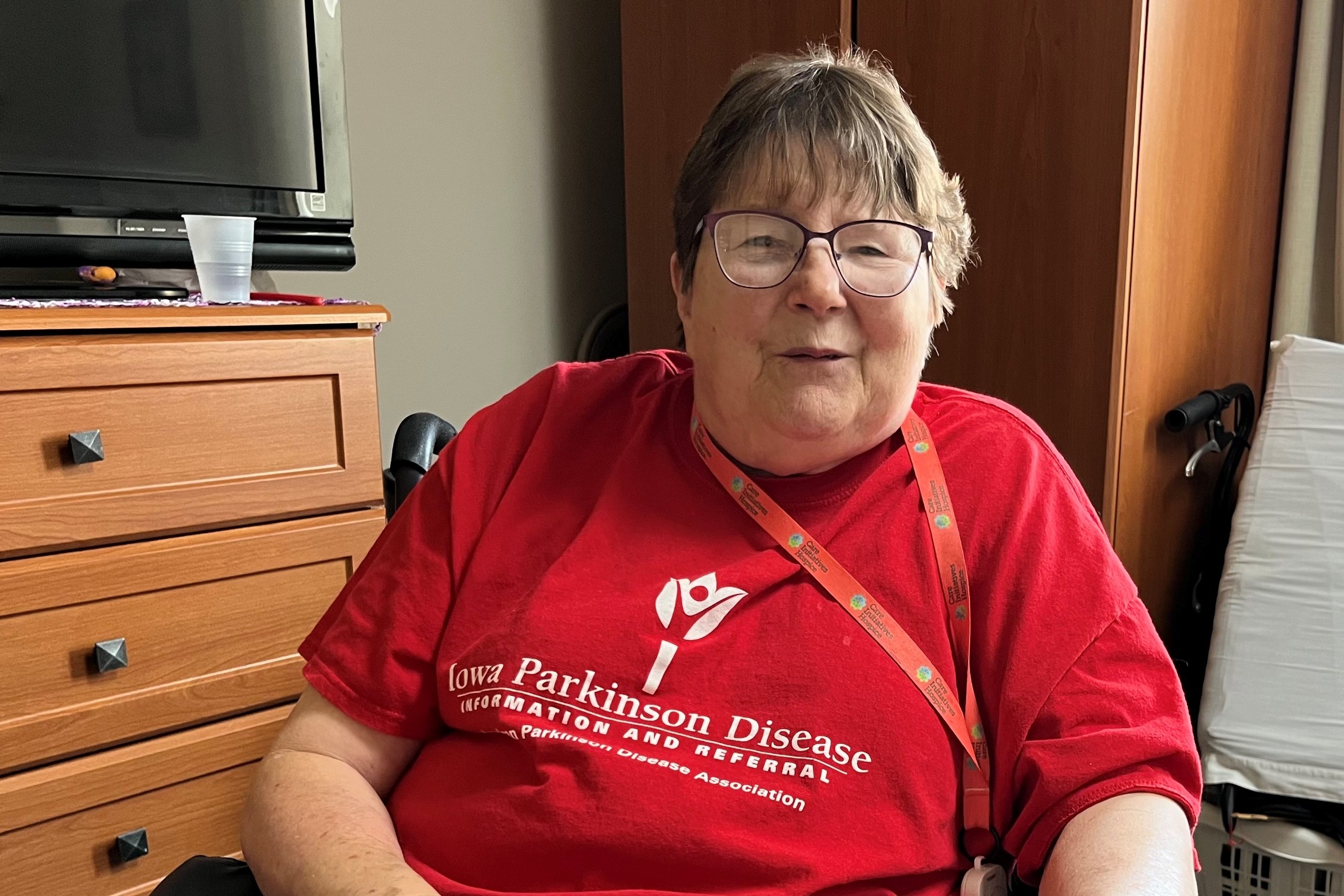 A photo of an older woman sitting in a nursing home.