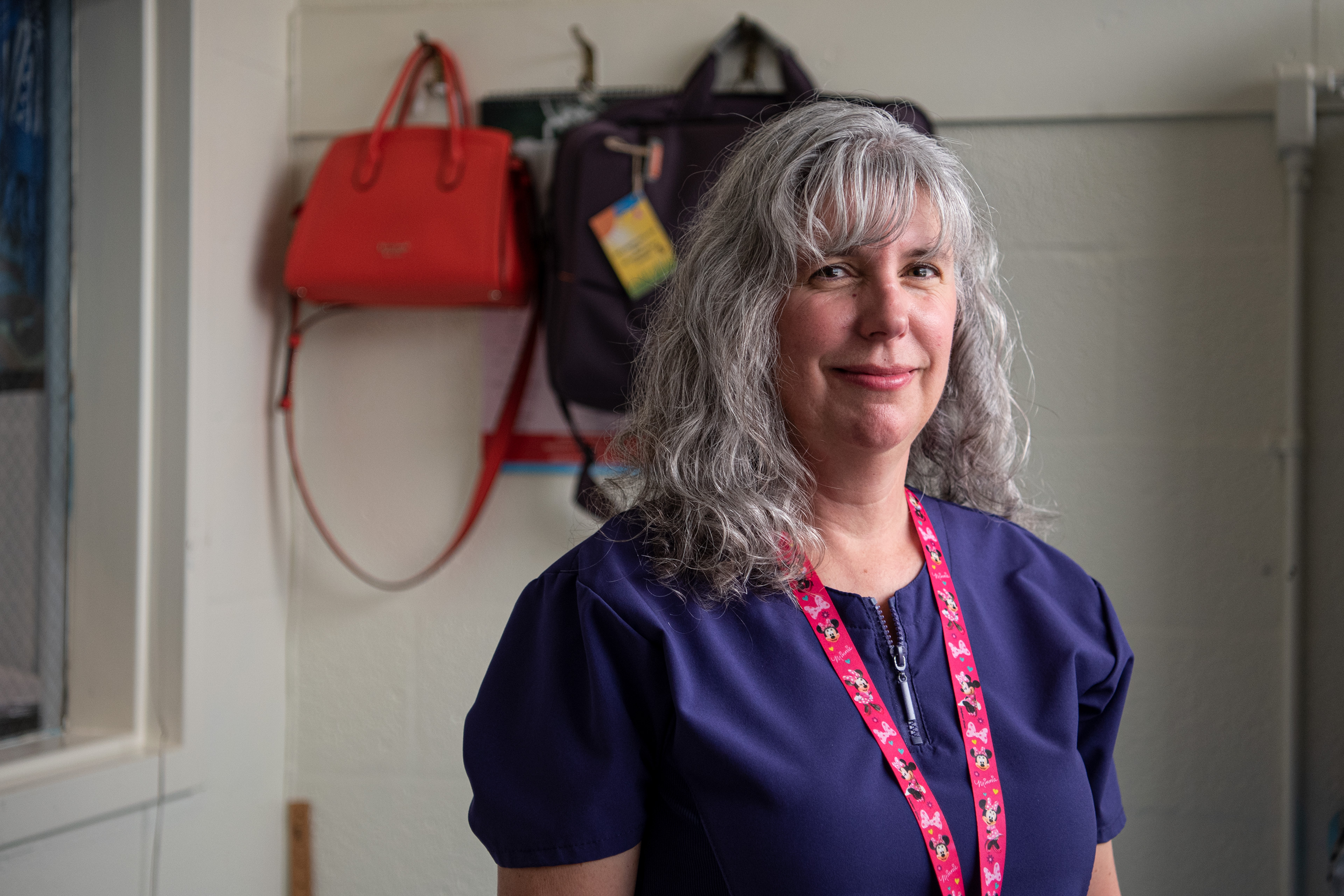 A photo of a school nurse standing by a window in her office.
