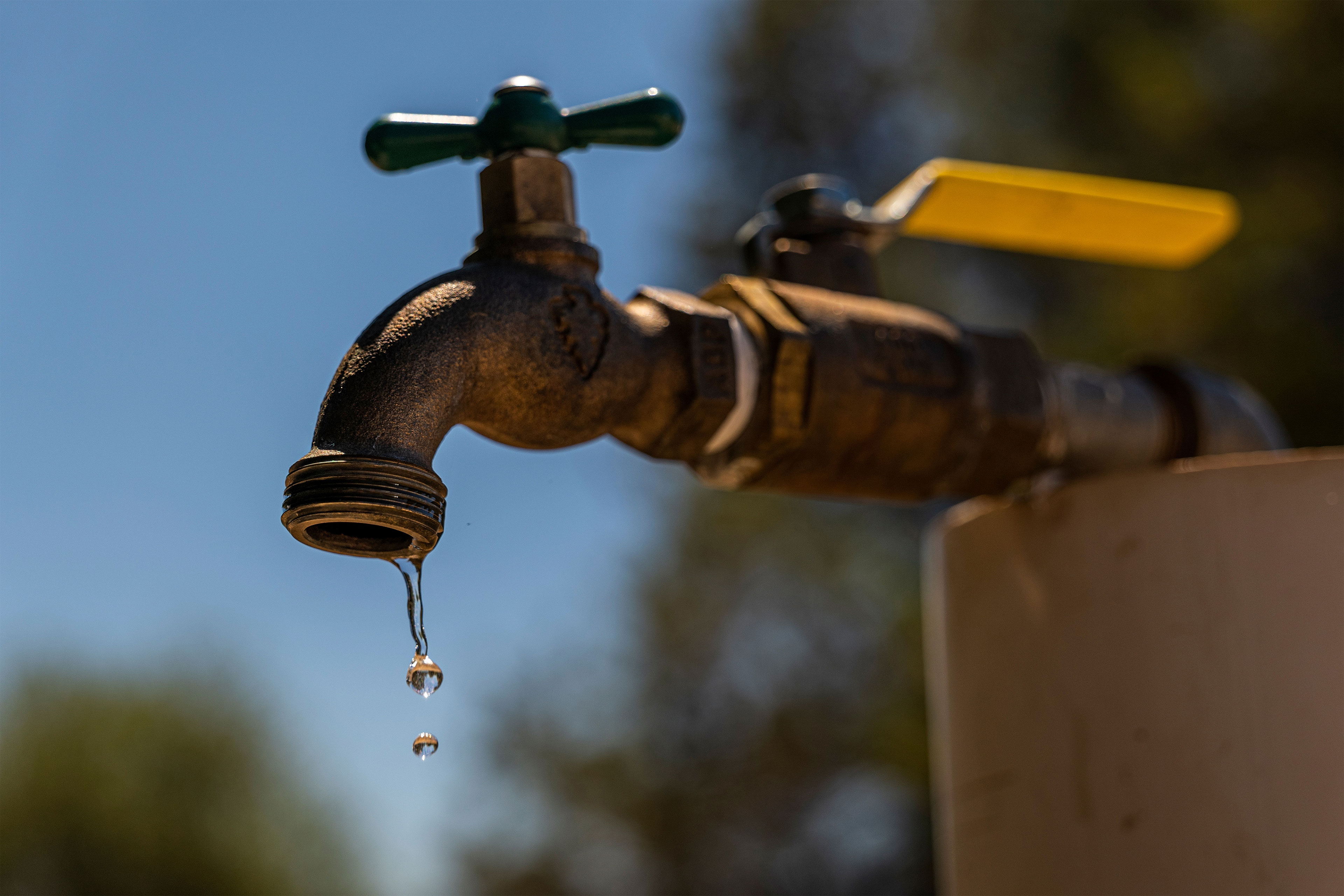 Water drips from a faucet outside.