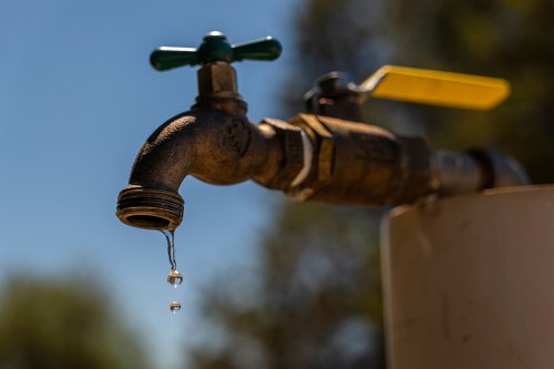 Water drips from a faucet outside.