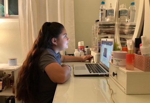 Anjelah Salazar, a fifth grade girl, sits at her desk in front of her computer.