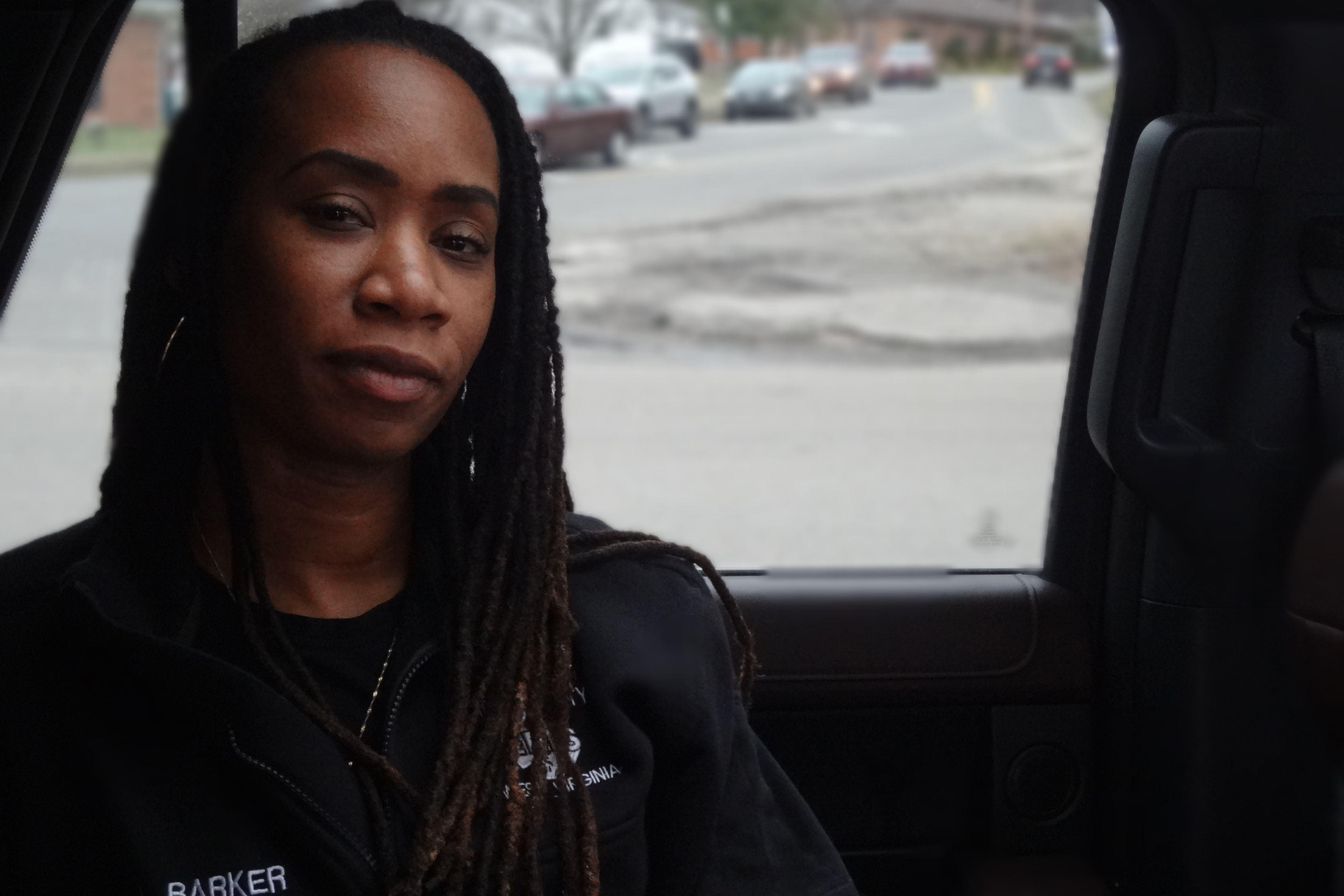 Larrecsa Barker looks towards the camera. She wears a sweatshirt that shows her name, "Barker."