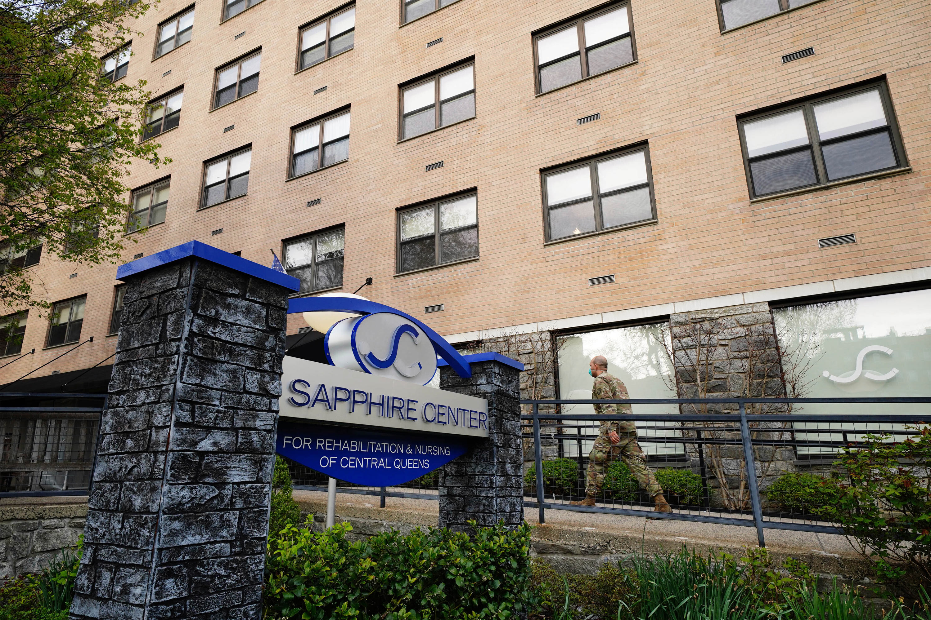 A photo from 2020 of a member the National Guard walking into Sapphire Center Nursing Home in New York.