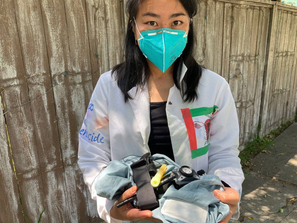 A photo of Elaine Chan holding supplies.