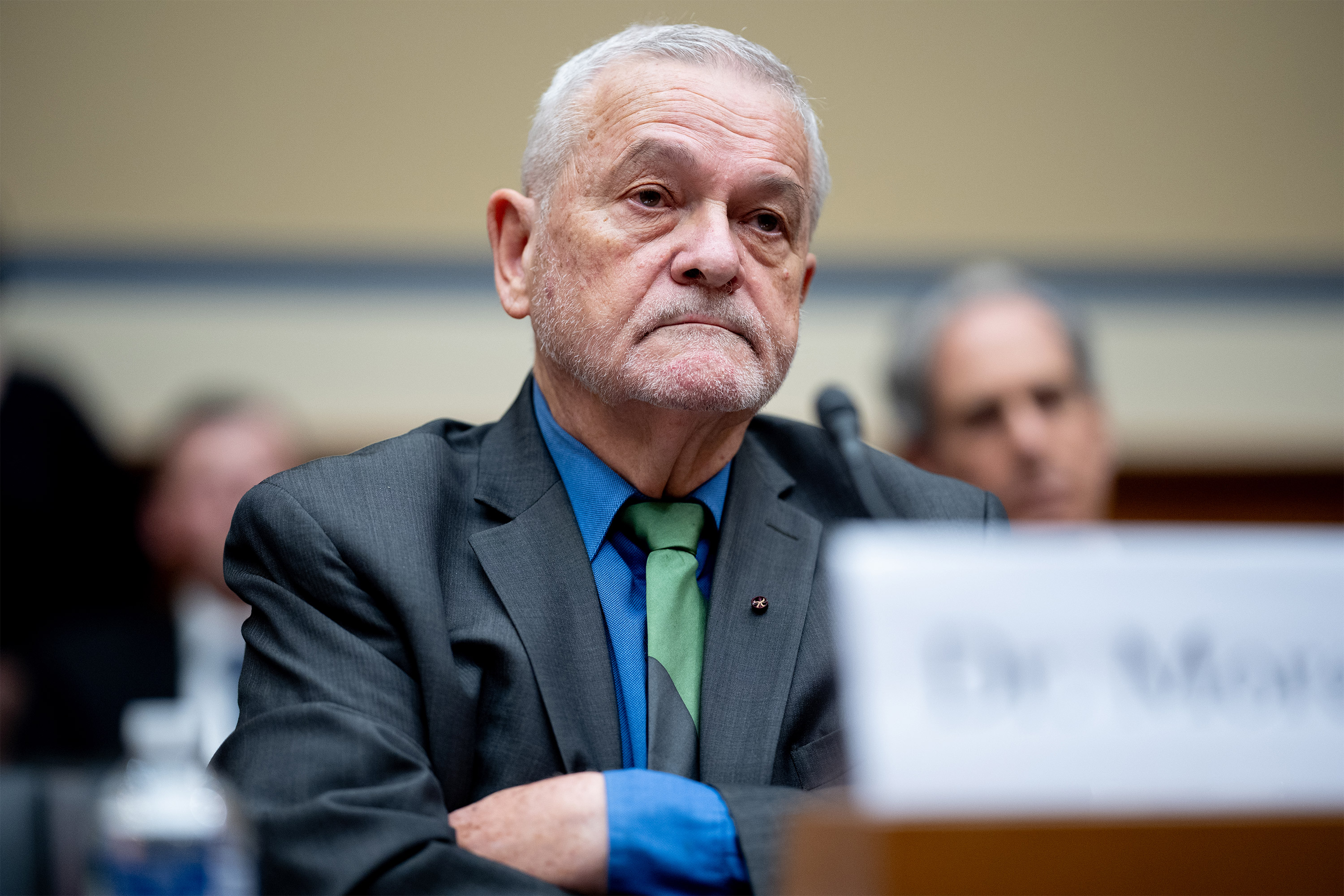 A photo of David Morens listening during a hearing inside the House of Representatives.