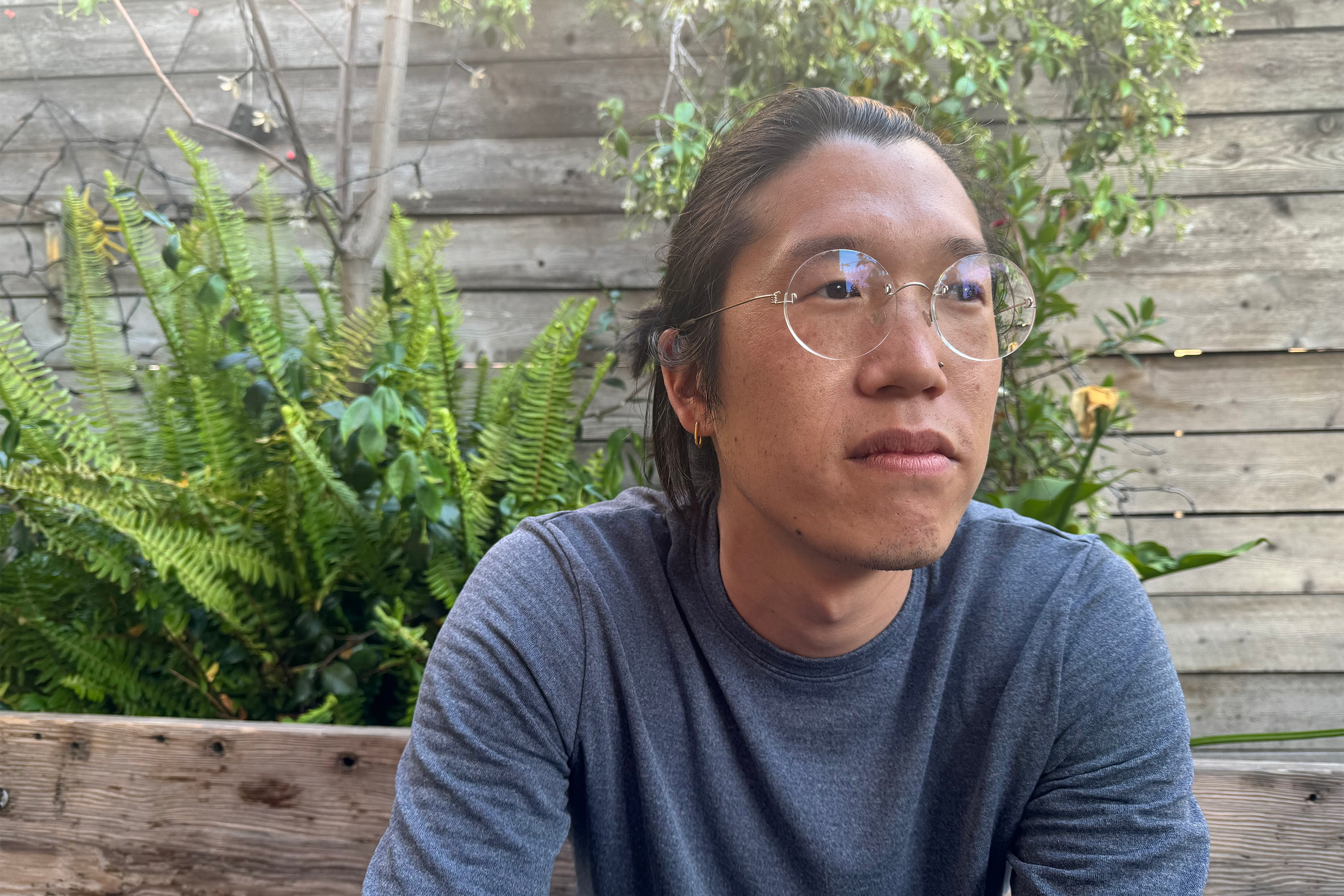 A photo of a man sitting outside for a portrait.