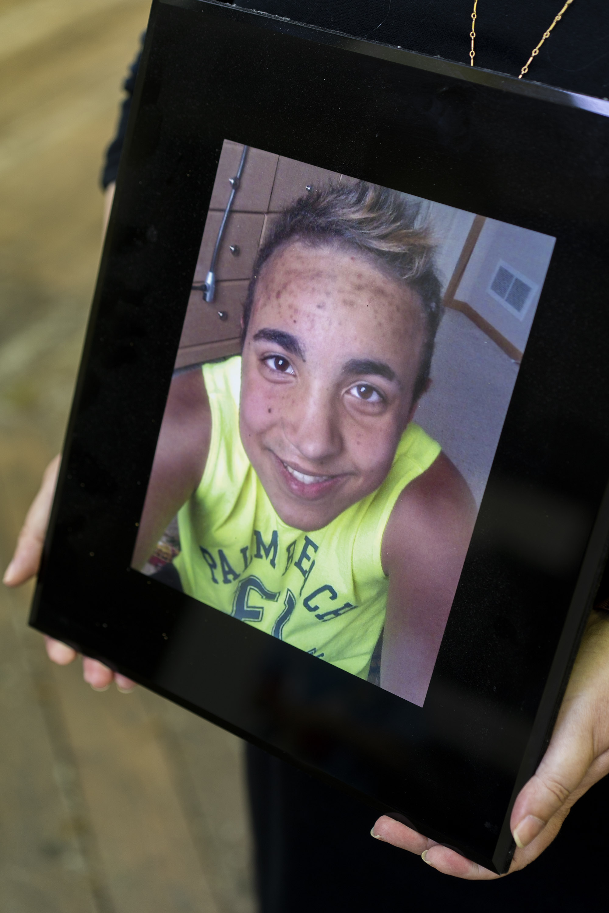 A photo of a framed picture of Sheryl Moore's late son.