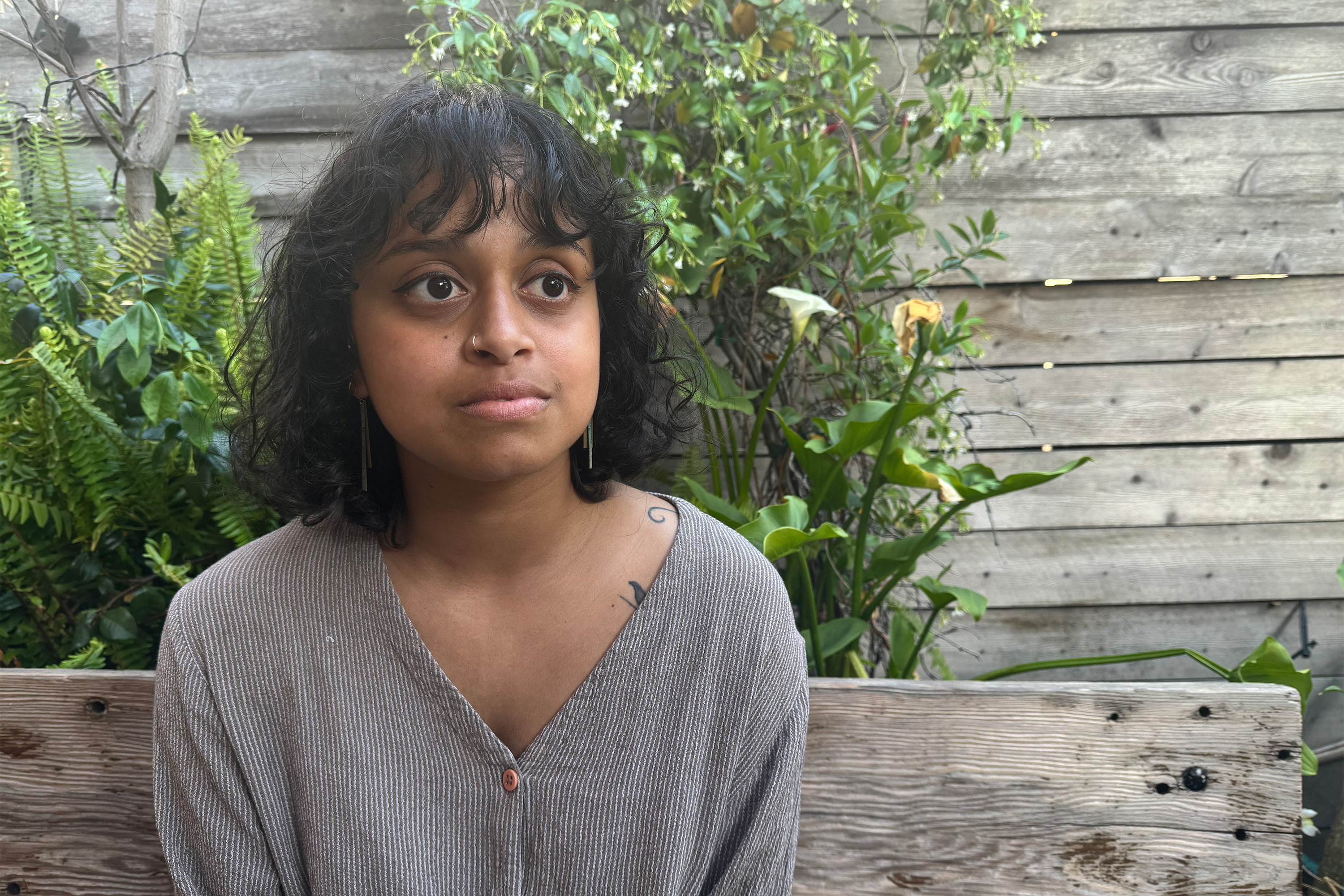 A photo of a woman sitting outside for a portrait.