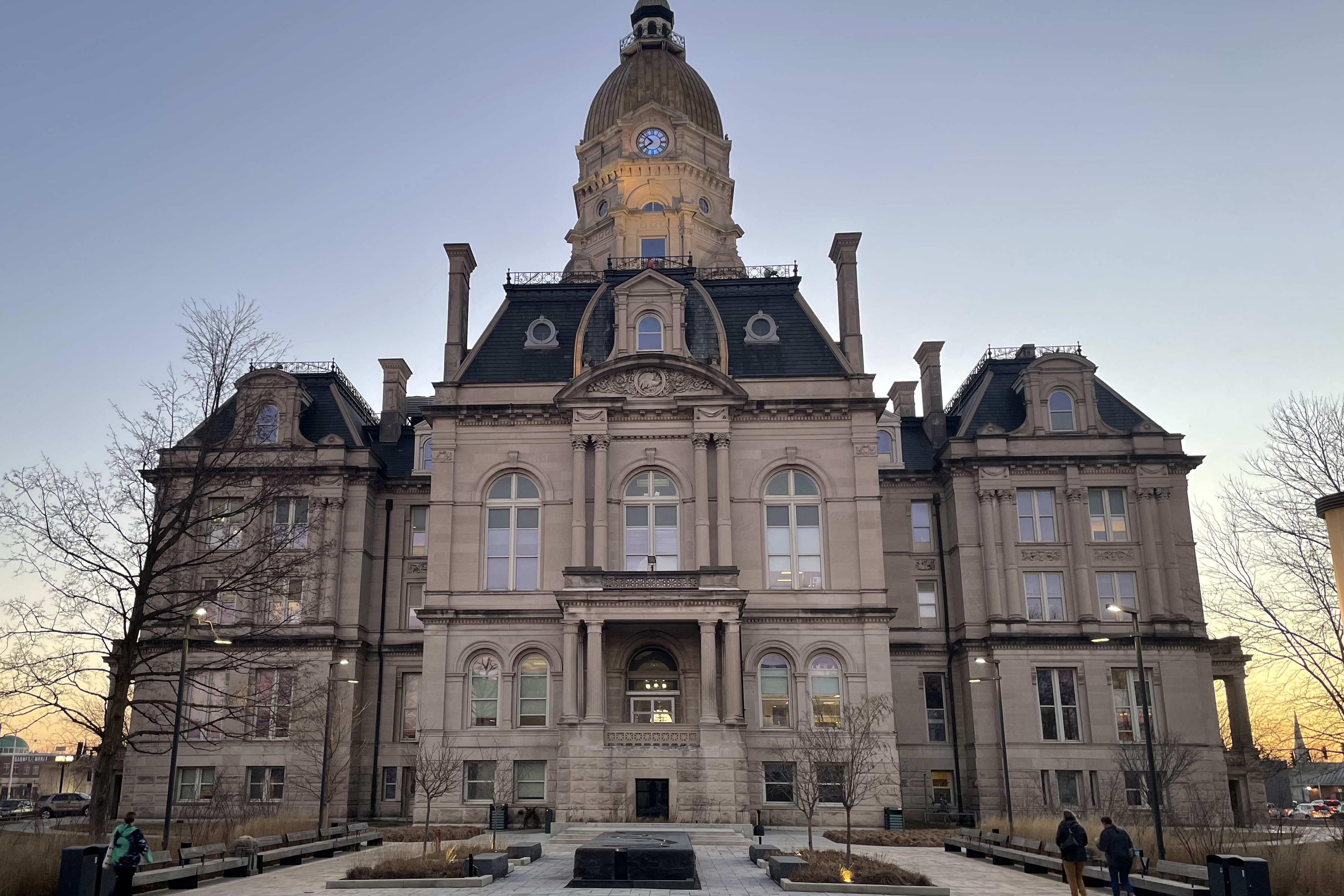 A sunset shot of Terra Haute's Vigo County Courthouse. It is an ornate building with a clock tower.