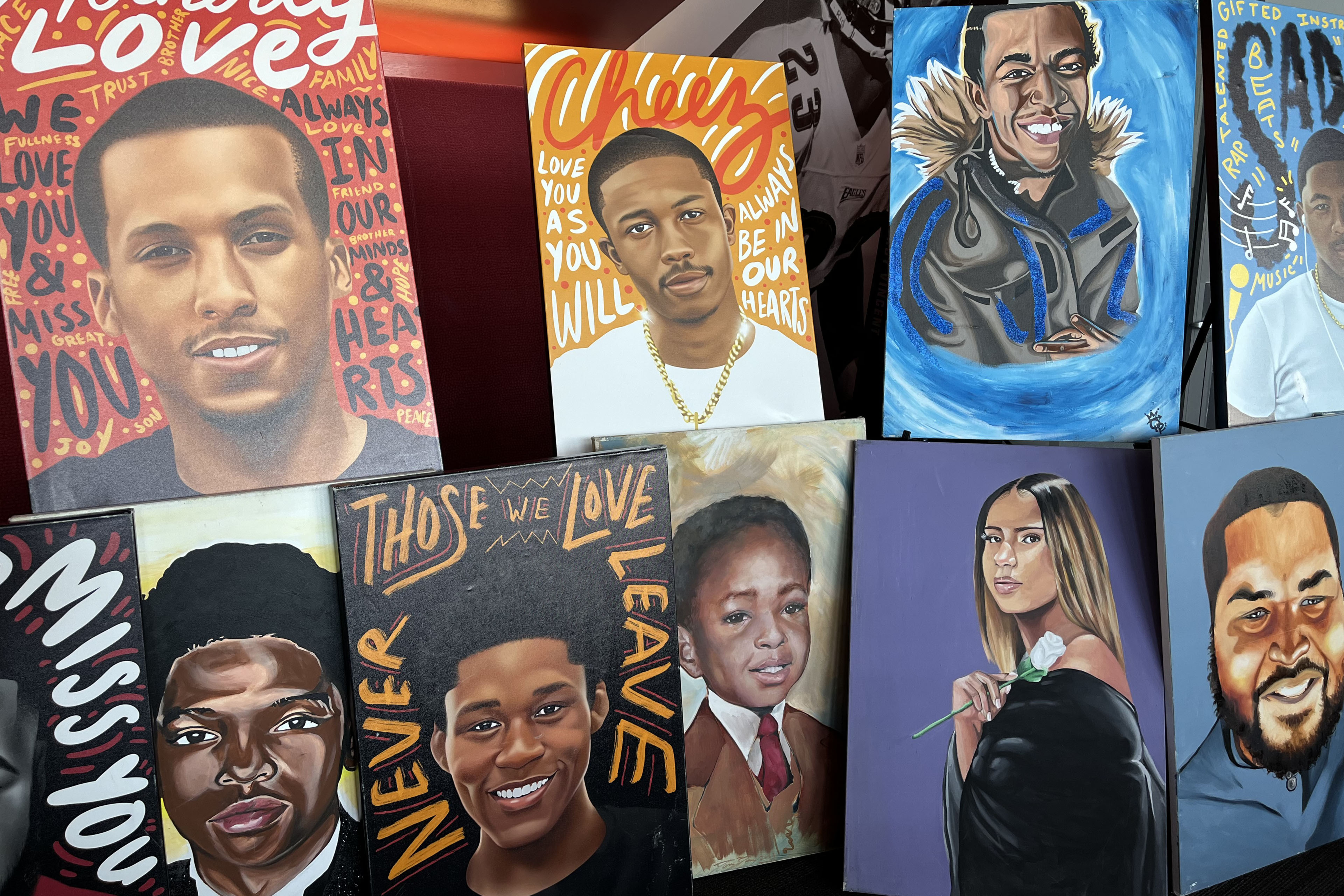 There are two rows of colorfully painted portraits. The top row has four paintings and the bottom row has five.