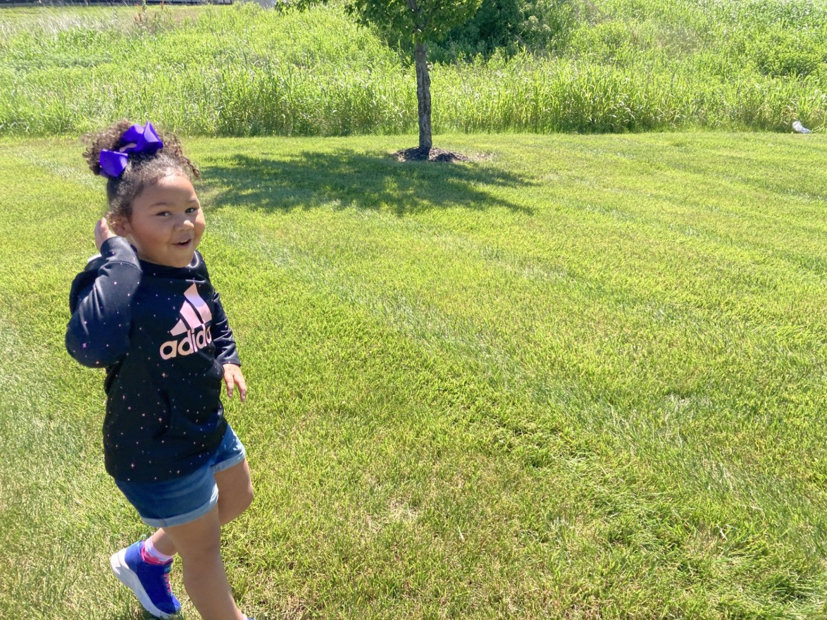 A photo of a young girl playing outside.