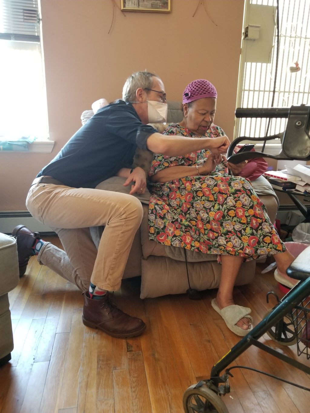 A doctor performs at home medical assessment of a senior female.
