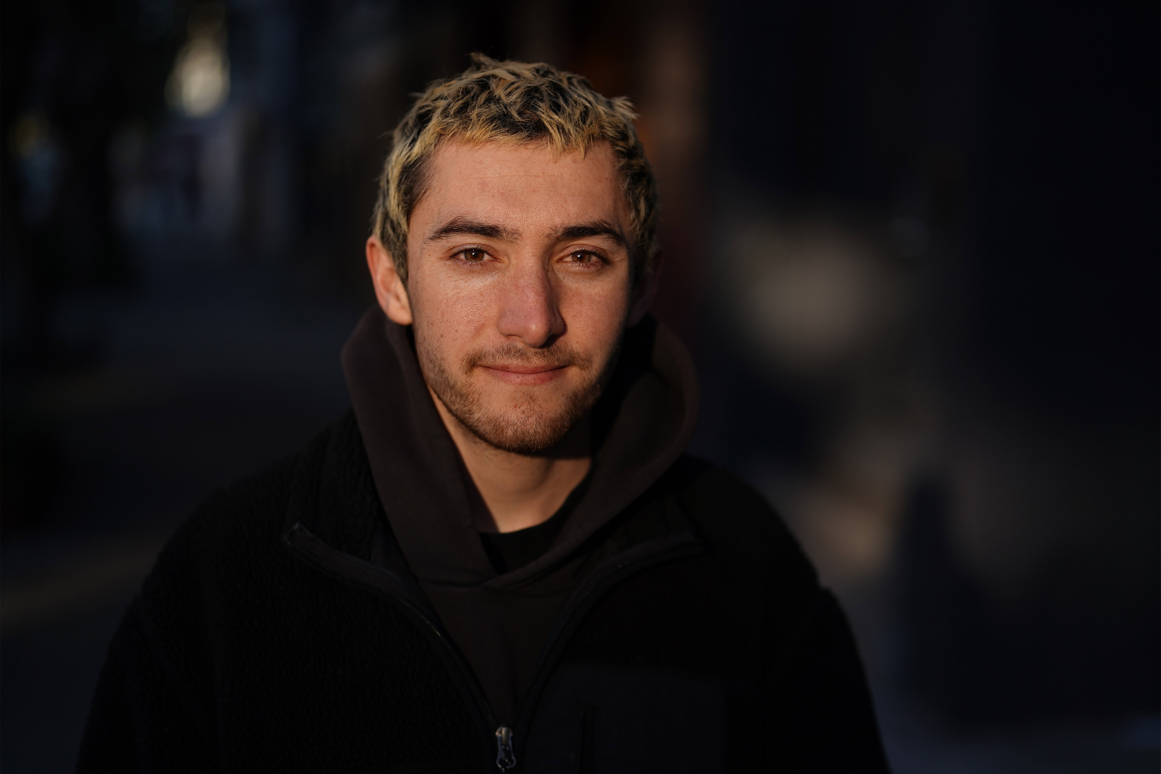 A photo of Jagdish Whitten posing for a portrait outside.
