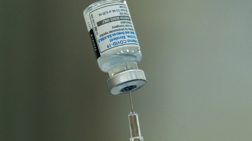 A close-up photo of a syringe inserted into a vial.