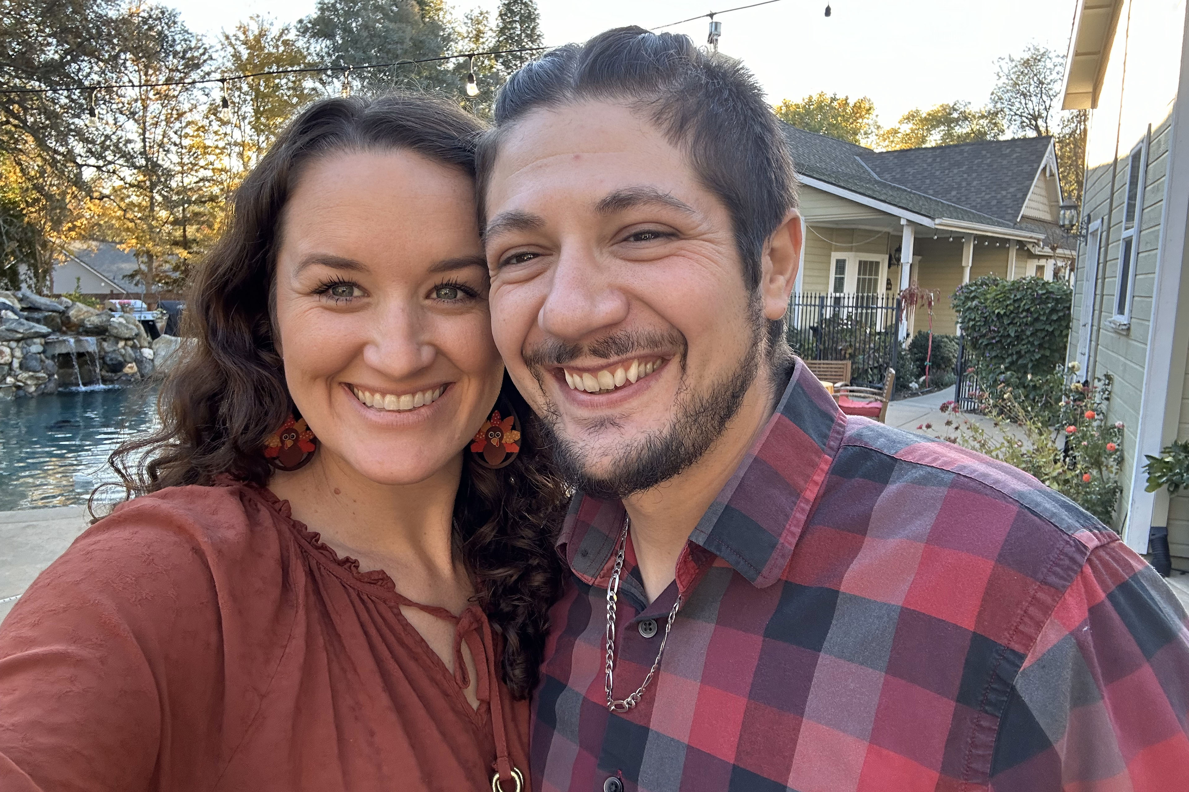 A selfie-style photo of a woman and man smiling together.